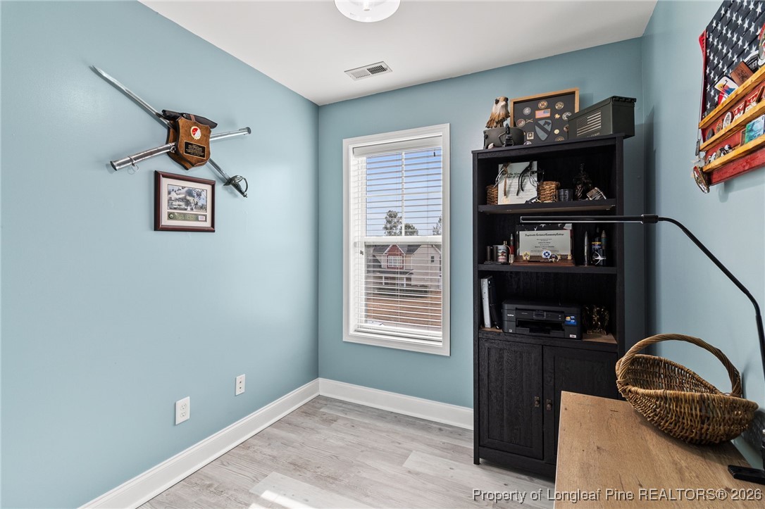 121 Colonist Place Cameron, NC 28326 - Photo 40 of 46 a picture of a living room with clothes and a window
