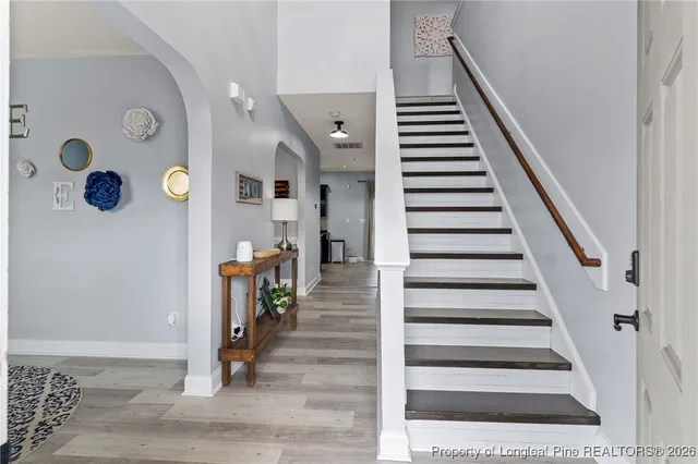 a view of entryway and hall with wooden floor