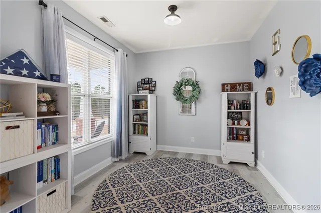 a view of a bedroom with furniture and window