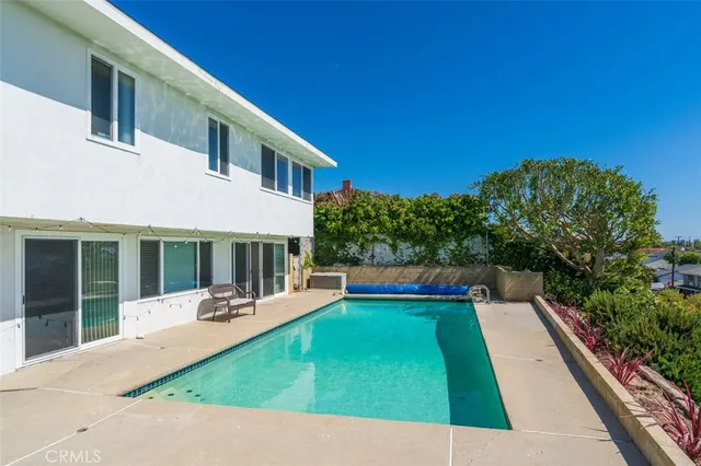 a view of house with swimming pool outdoor seating