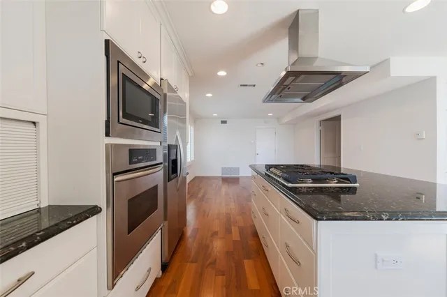 a kitchen with granite countertop a stove and a sink
