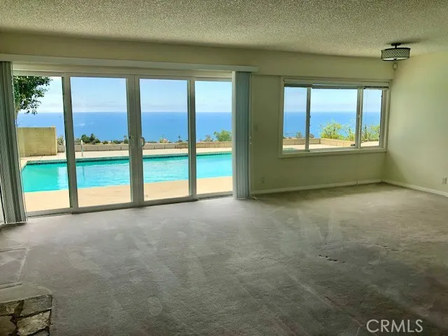 an empty room with large windows