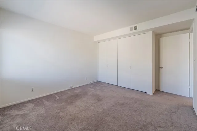 an empty room with closet area