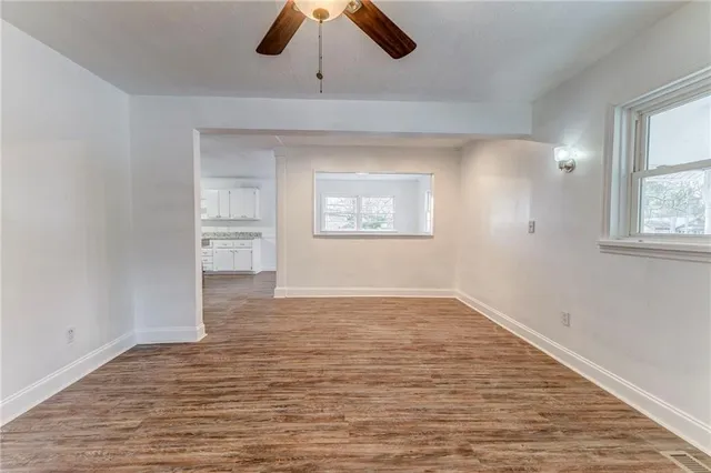 wooden floor in an empty room with a window