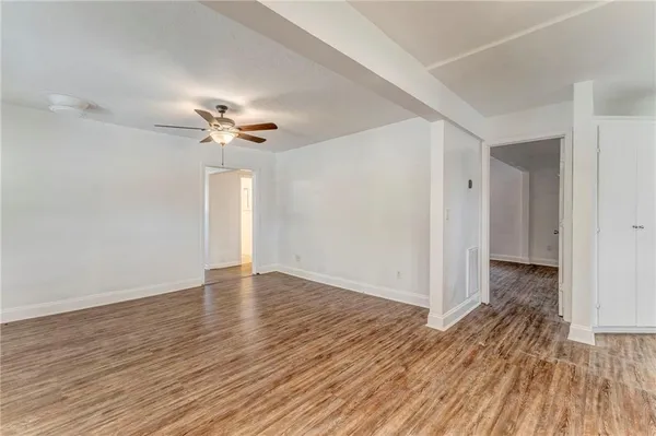 wooden floor in an empty room with a window