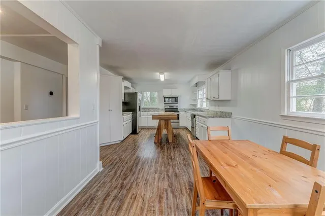 a dining room with furniture and wooden floor