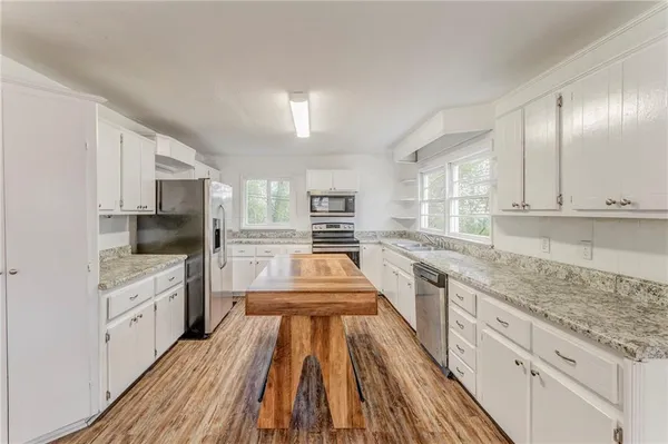 a kitchen with a sink stove and refrigerator