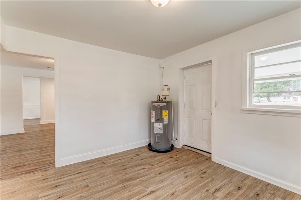 2888 Old Summerville Road Armuchee, GA 30105 - Photo 9 of 37 an empty room with wooden floor and windows