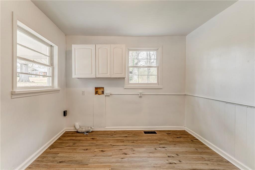 2888 Old Summerville Road Armuchee, GA 30105 - Photo 10 of 37 a view of a kitchen with wooden floor and a window