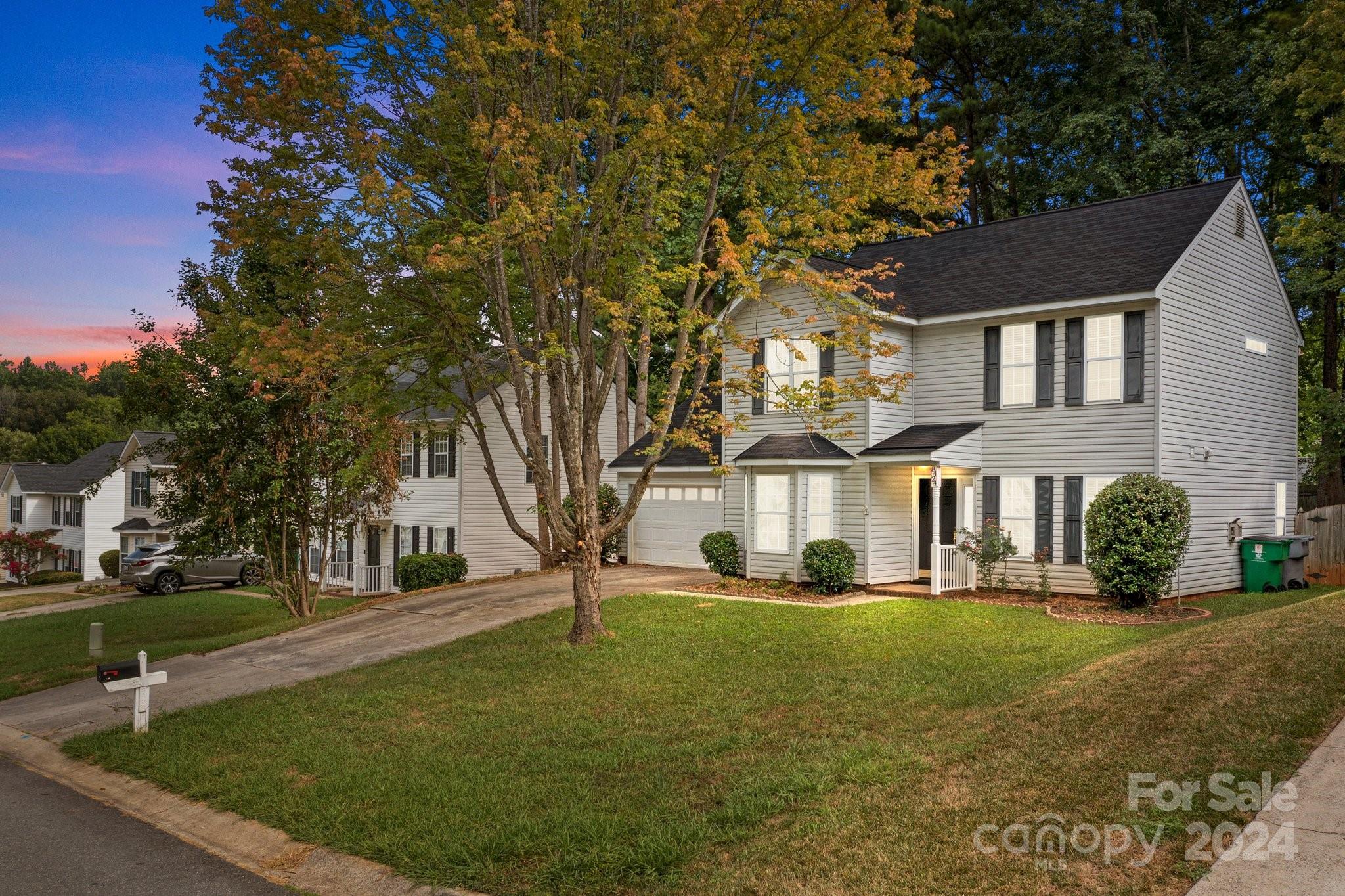 8424 Conner Ridge Lane Charlotte, NC 28269 - Photo 1 of 48 a front view of a house with a yard