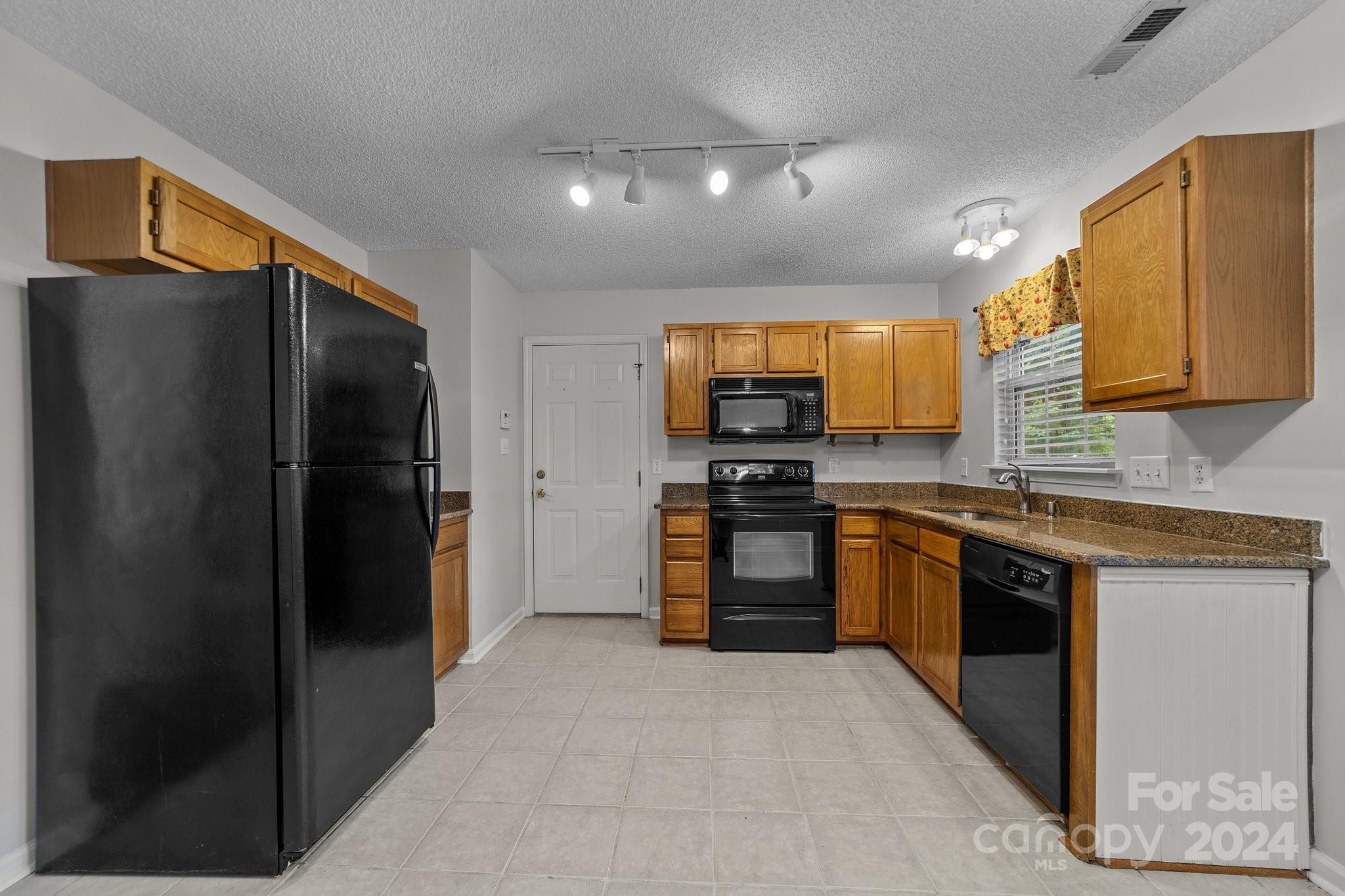 8424 Conner Ridge Lane Charlotte, NC 28269 - Photo 19 of 48 a kitchen with stainless steel appliances granite countertop a refrigerator and a stove top oven