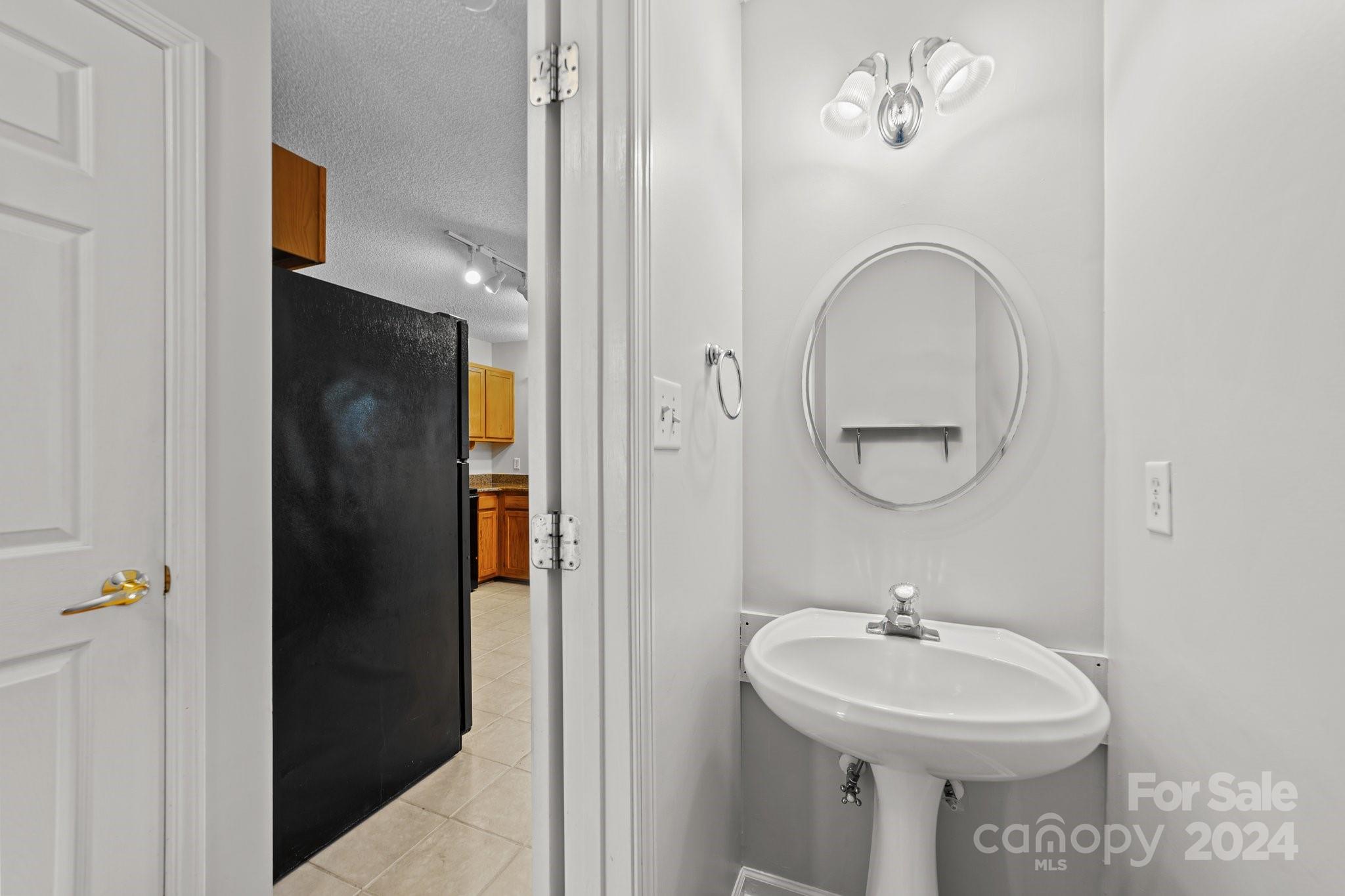8424 Conner Ridge Lane Charlotte, NC 28269 - Photo 21 of 48 a bathroom with a sink and mirror