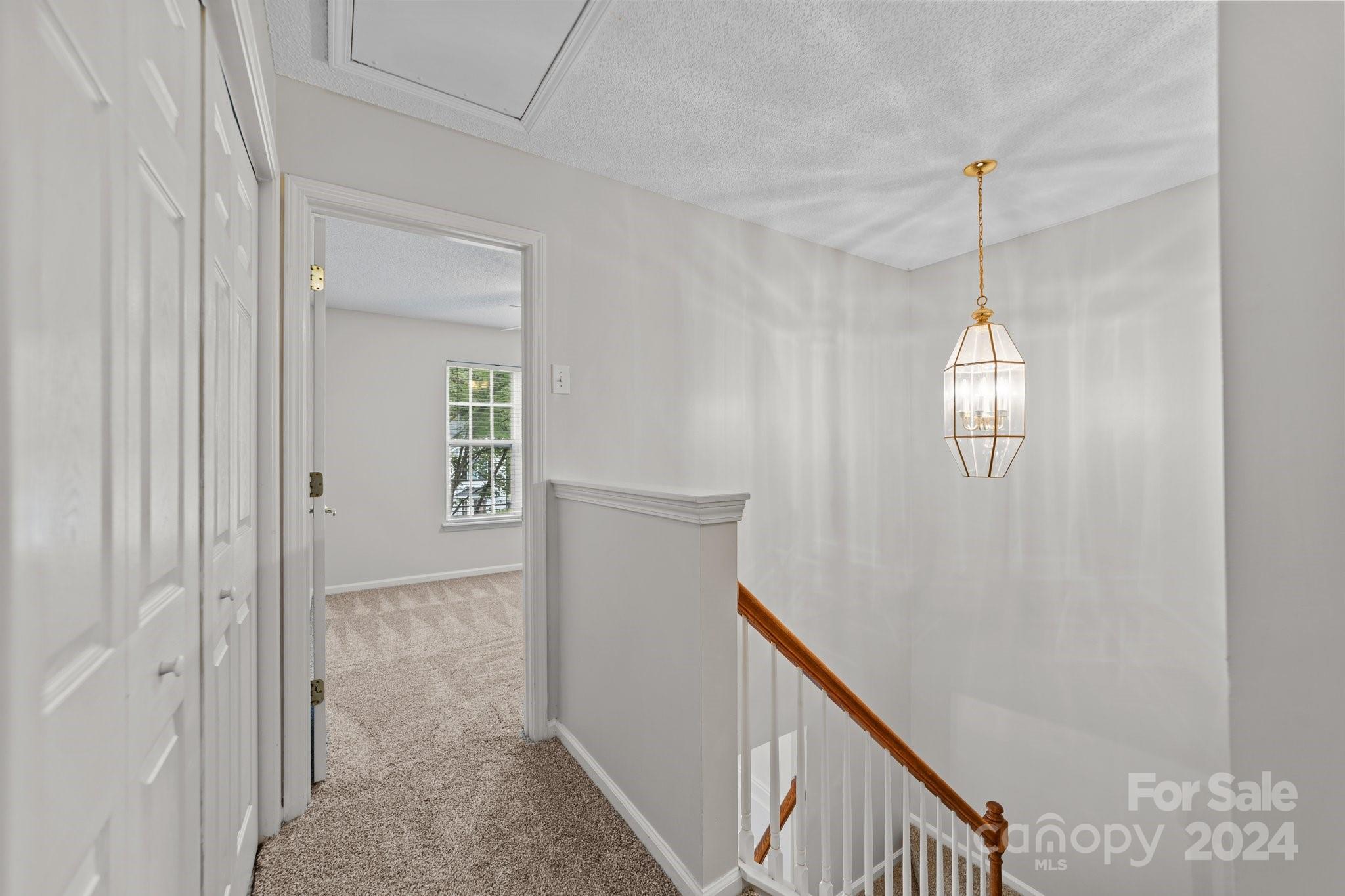 8424 Conner Ridge Lane Charlotte, NC 28269 - Photo 22 of 48 a view of a hallway with windows and stairs