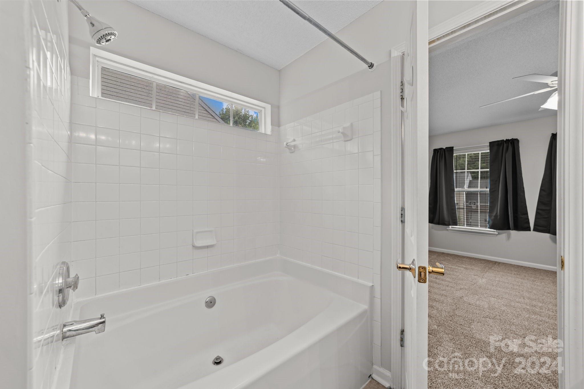 8424 Conner Ridge Lane Charlotte, NC 28269 - Photo 27 of 48 a bathroom with a bathtub and a shower