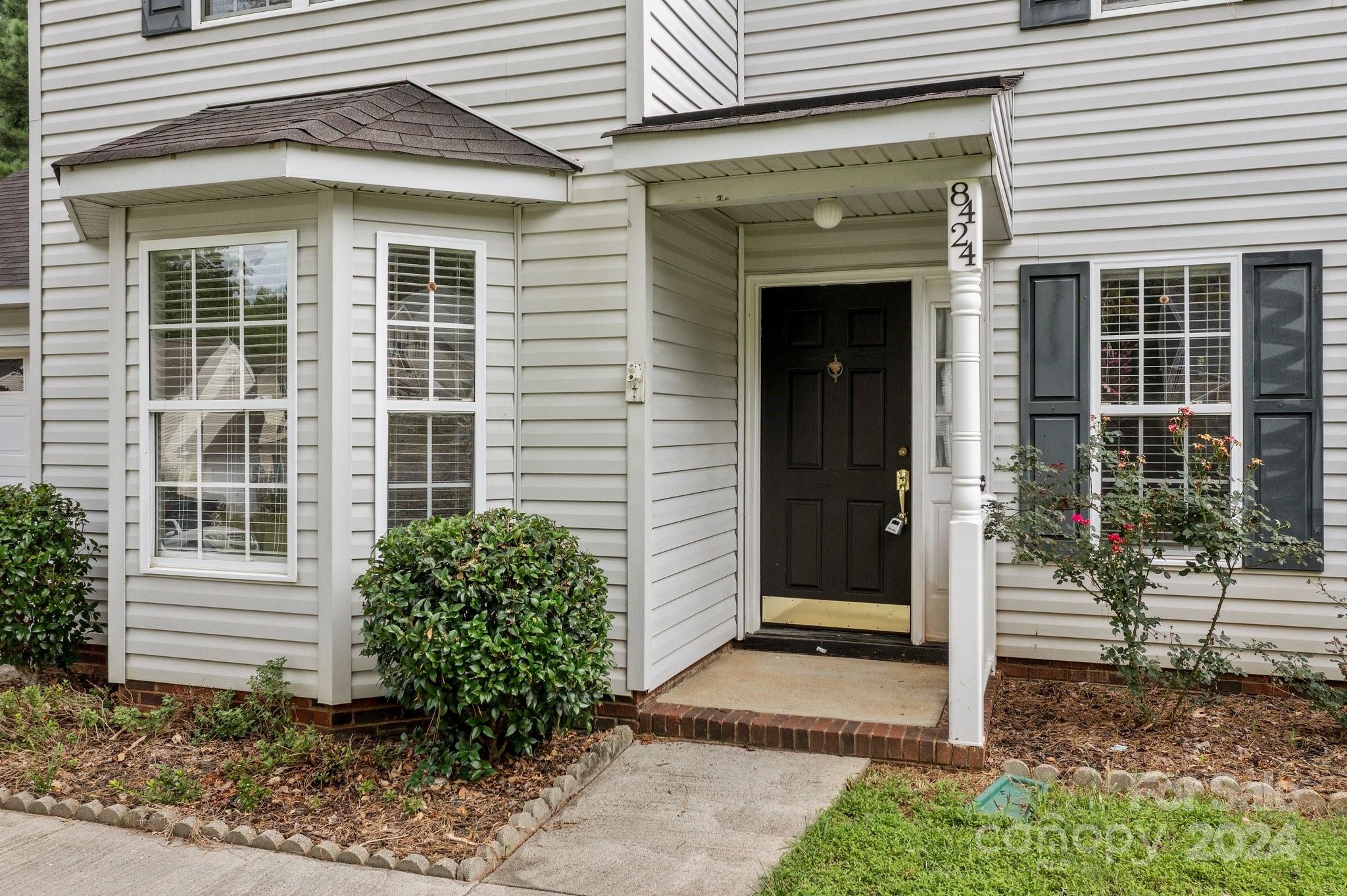 8424 Conner Ridge Lane Charlotte, NC 28269 - Photo 3 of 48 a front view of a house with a garden