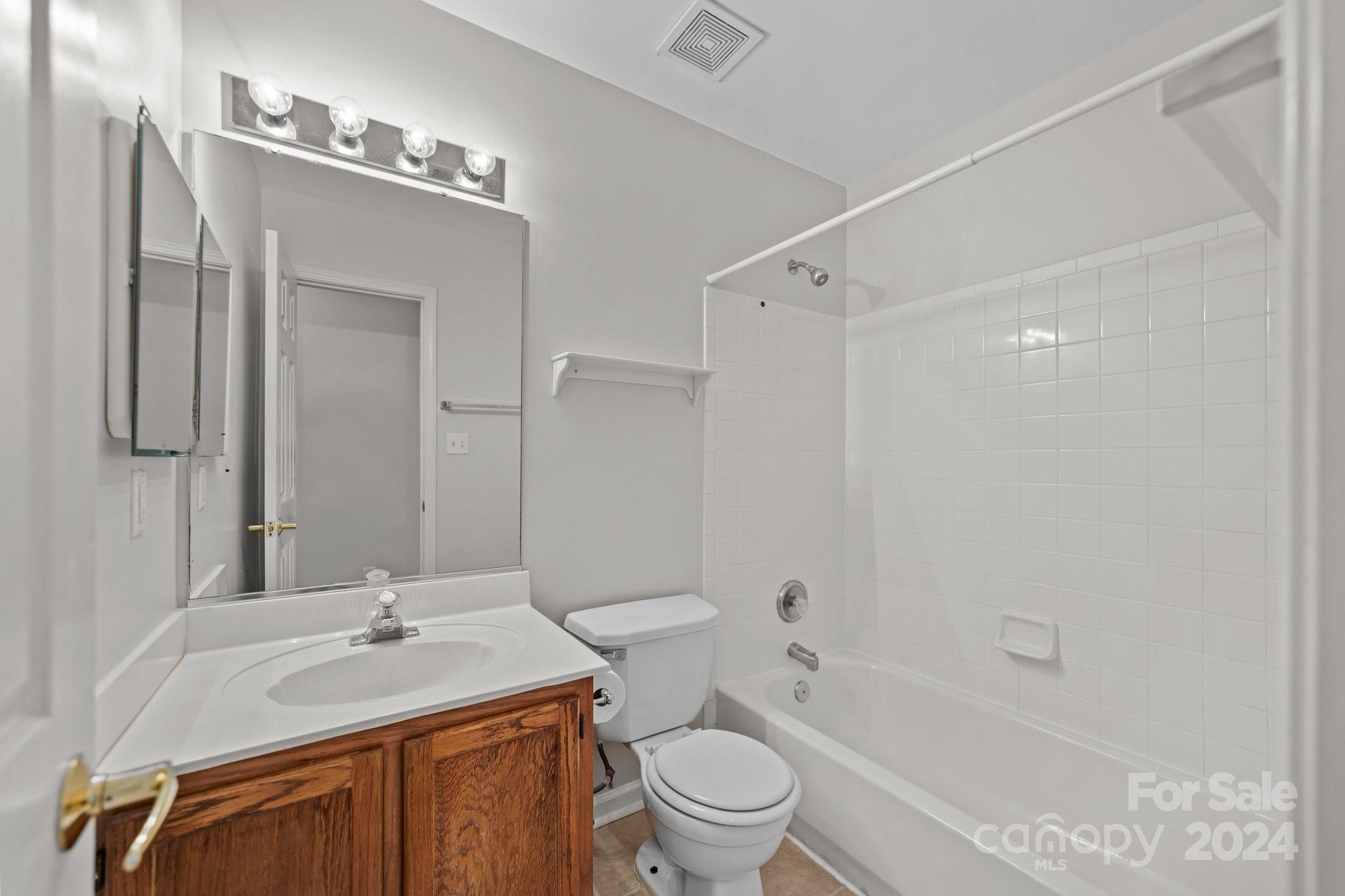 8424 Conner Ridge Lane Charlotte, NC 28269 - Photo 33 of 48 a bathroom with a sink toilet vanity and shower