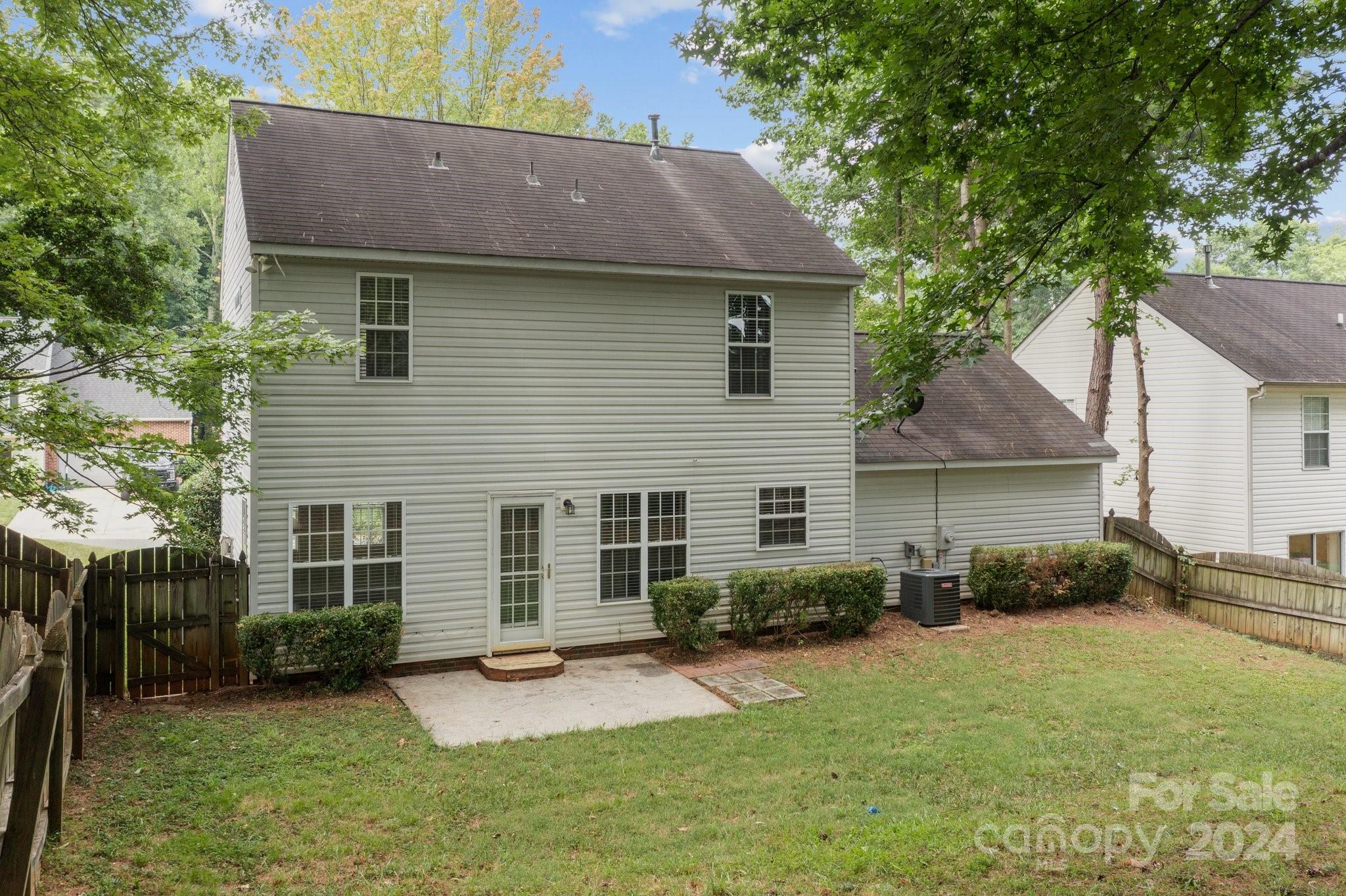 8424 Conner Ridge Lane Charlotte, NC 28269 - Photo 40 of 48 a view of a house with a yard and plants