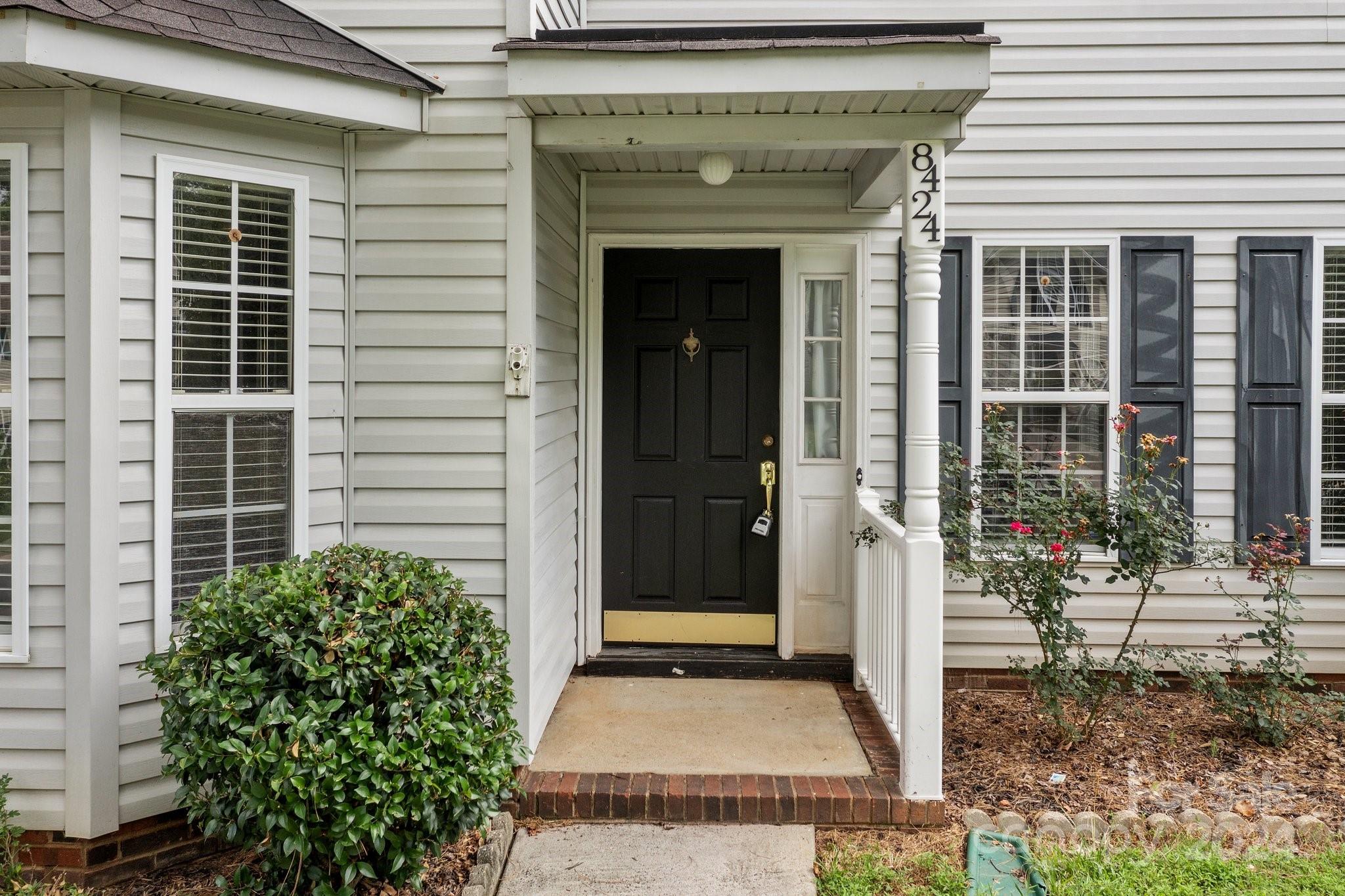 8424 Conner Ridge Lane Charlotte, NC 28269 - Photo 4 of 48 a front view of a house with a porch