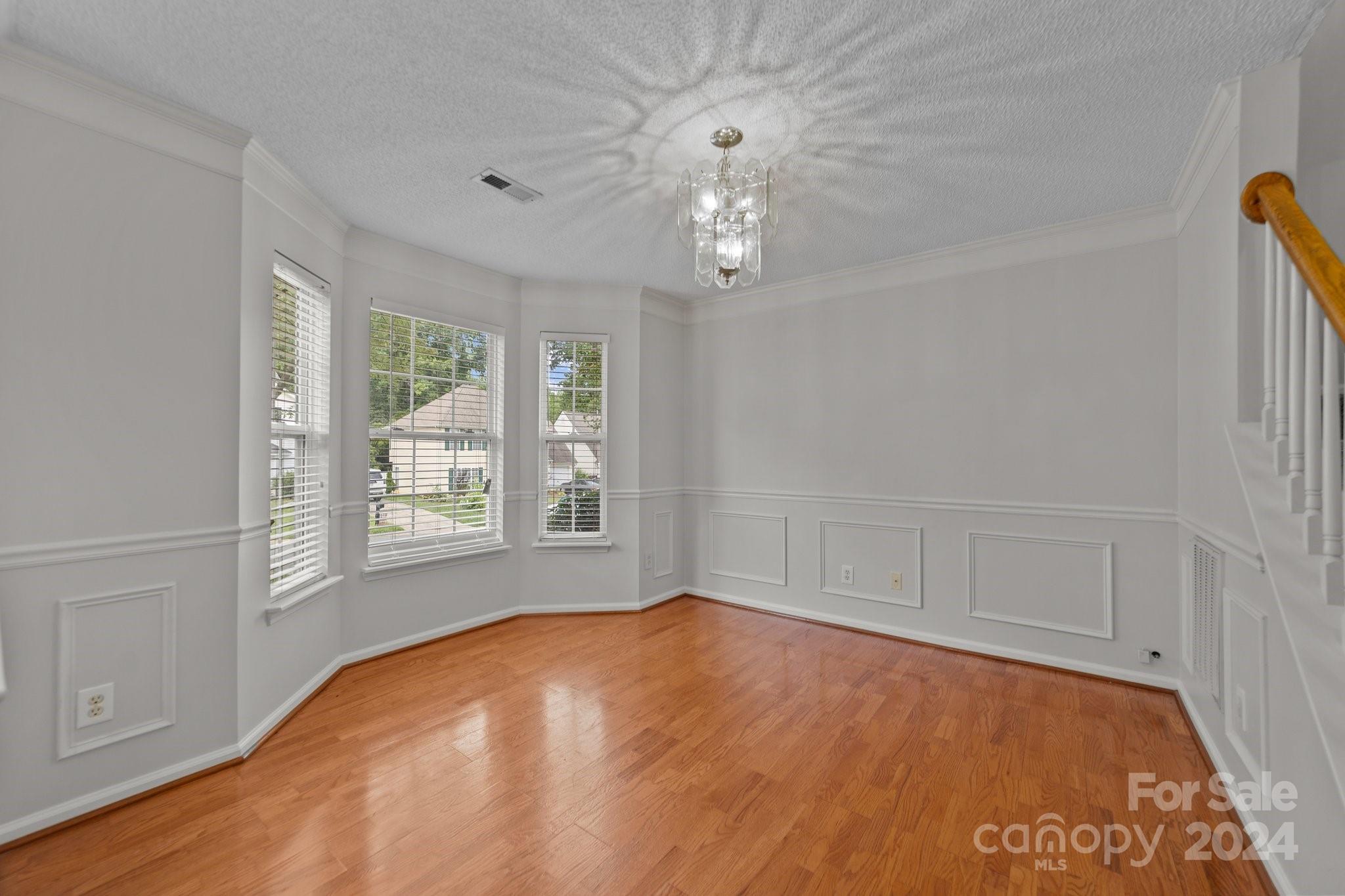 8424 Conner Ridge Lane Charlotte, NC 28269 - Photo 8 of 48 wooden floor in an empty room with a window