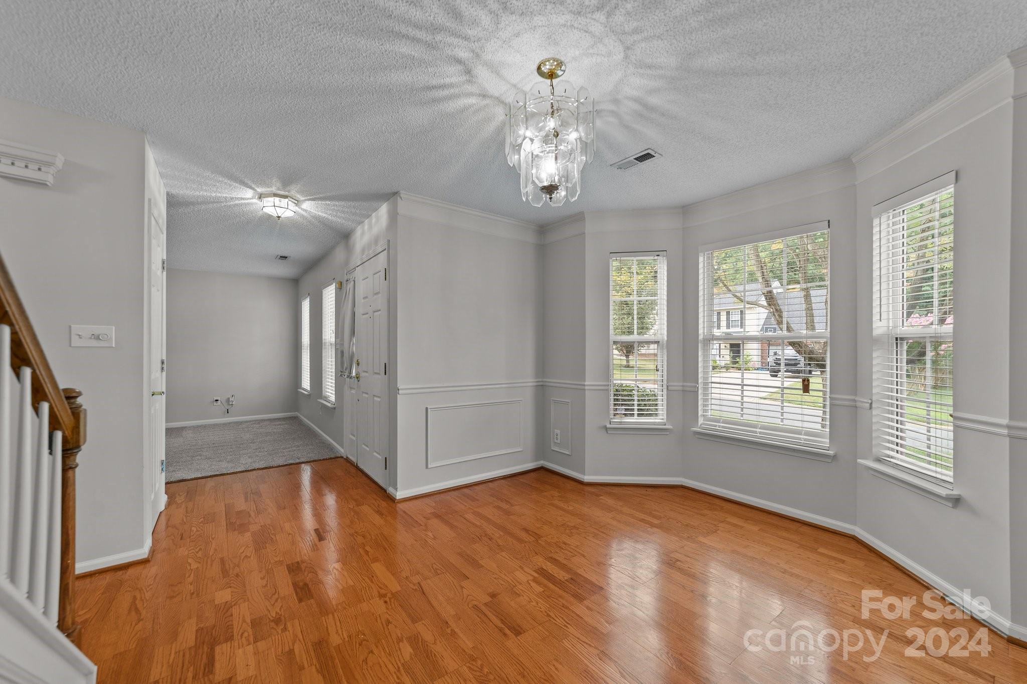 8424 Conner Ridge Lane Charlotte, NC 28269 - Photo 9 of 48 a view of an empty room with a window and wooden floor