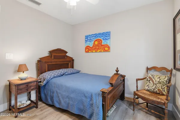 a bedroom with a bed and a couch