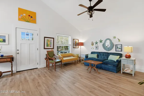 a living room with furniture and a wooden floor