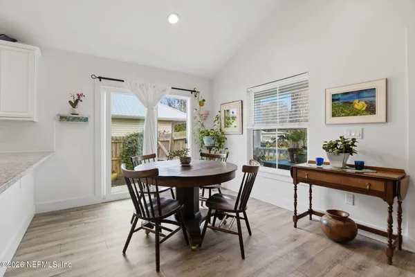 a view of a dining room with furniture and window