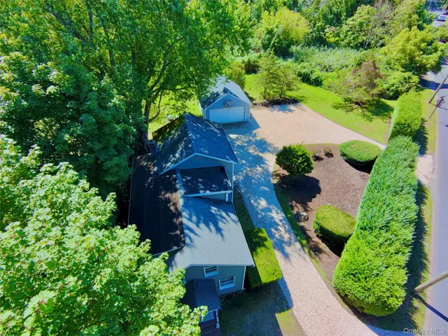 an aerial view of a house with a yard and garden