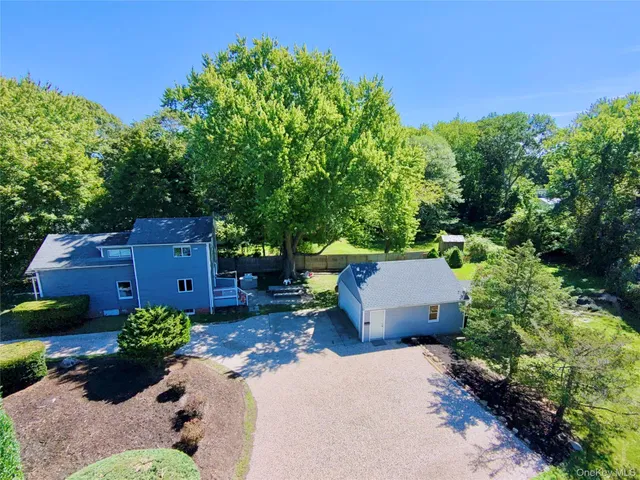 an aerial view of a house with a yard and outdoor seating