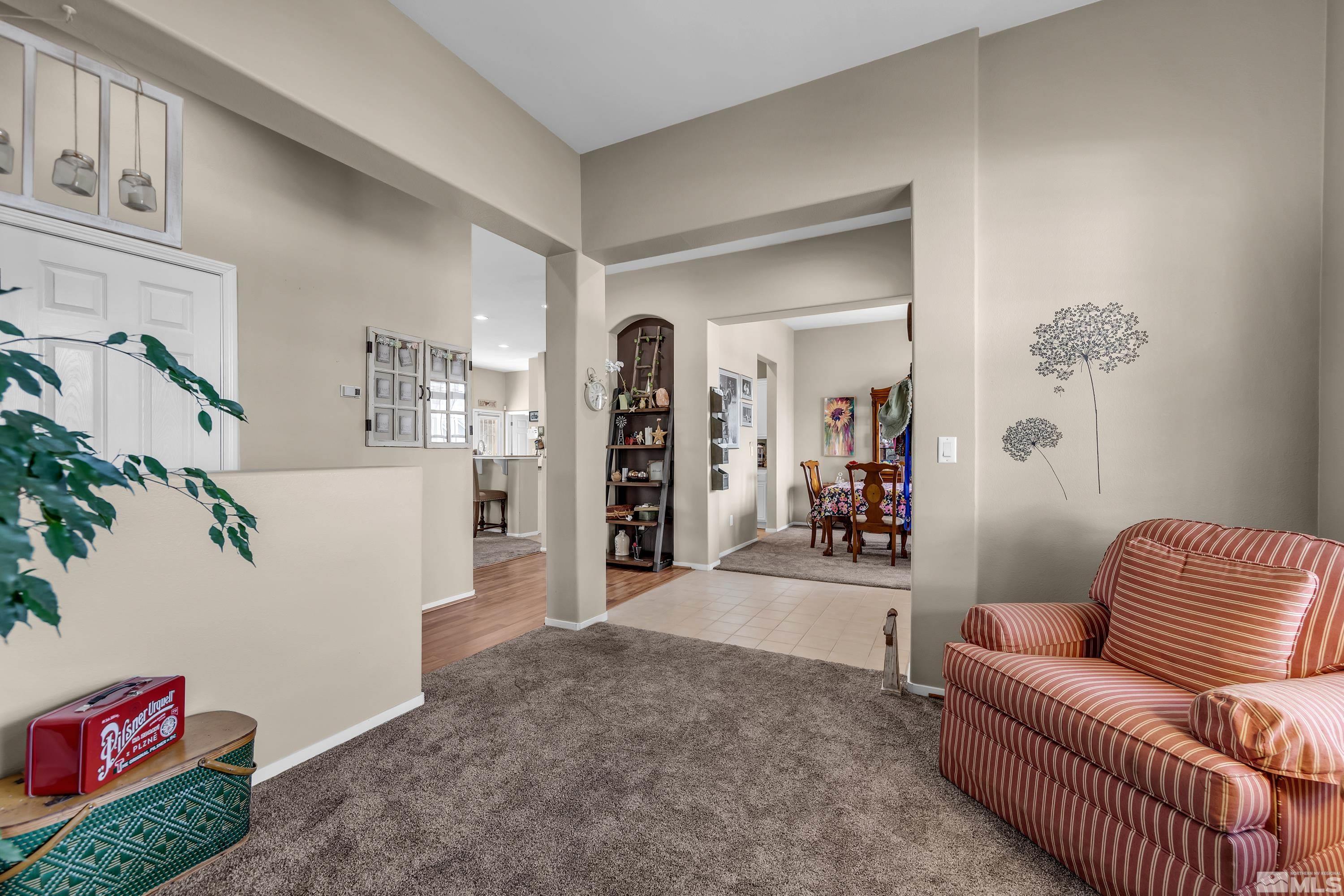 1496 Gaucho Lane Reno, NV 89521 - Photo 12 of 40 a living room with furniture and a chandelier