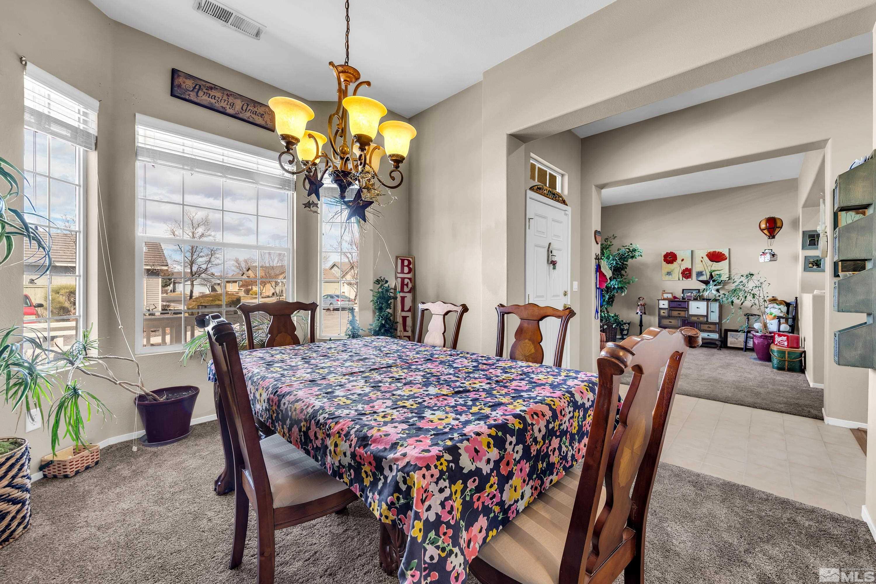 1496 Gaucho Lane Reno, NV 89521 - Photo 14 of 40 a view of a dining room with furniture window and outside view