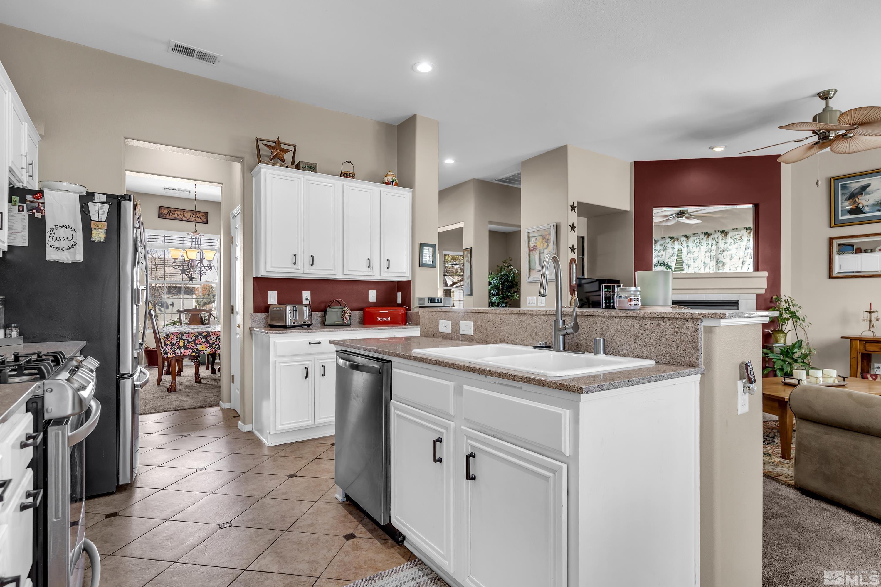 1496 Gaucho Lane Reno, NV 89521 - Photo 19 of 40 a kitchen with a sink stove and cabinets