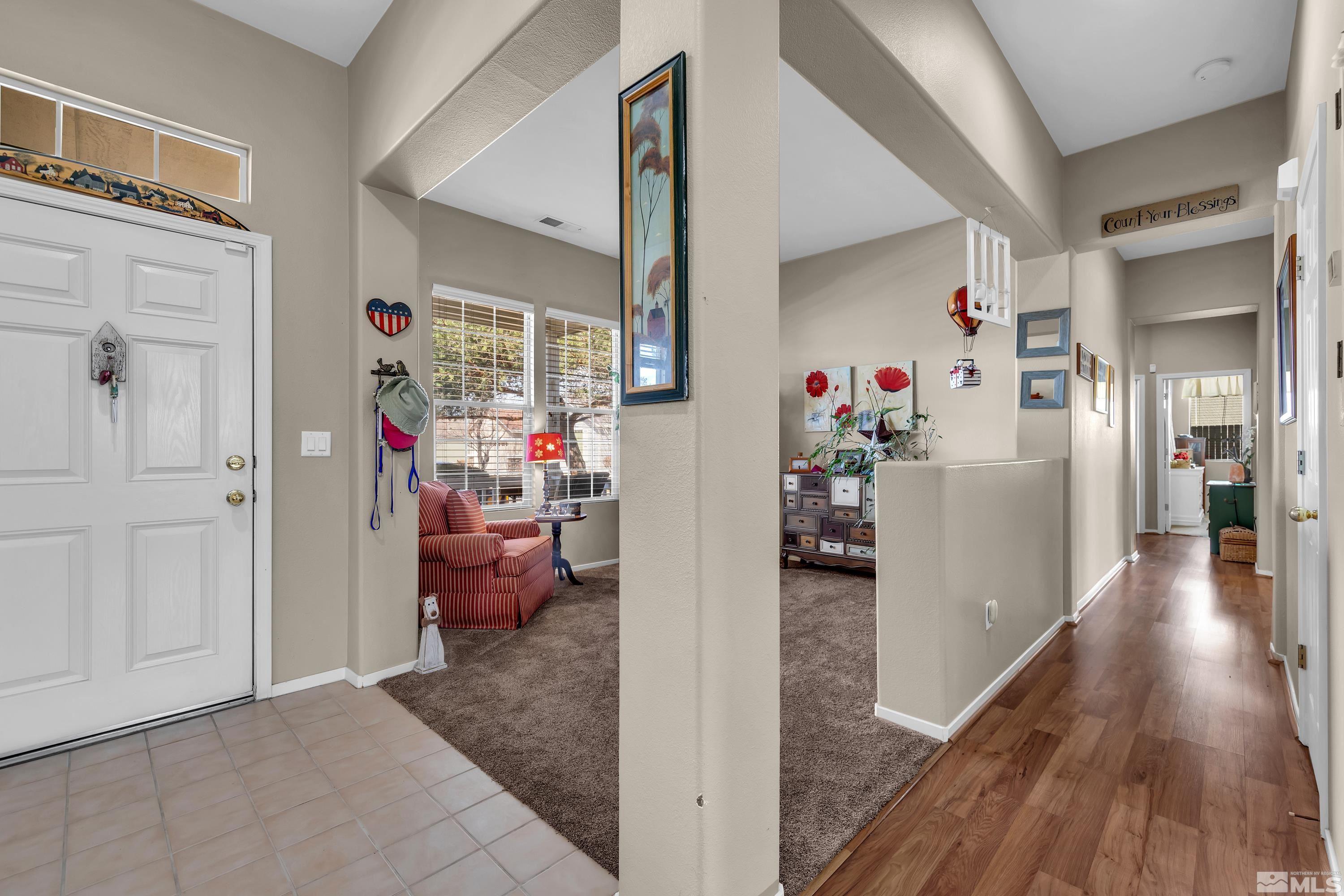 1496 Gaucho Lane Reno, NV 89521 - Photo 21 of 40 a view of a hallway view with wooden floor and furniture