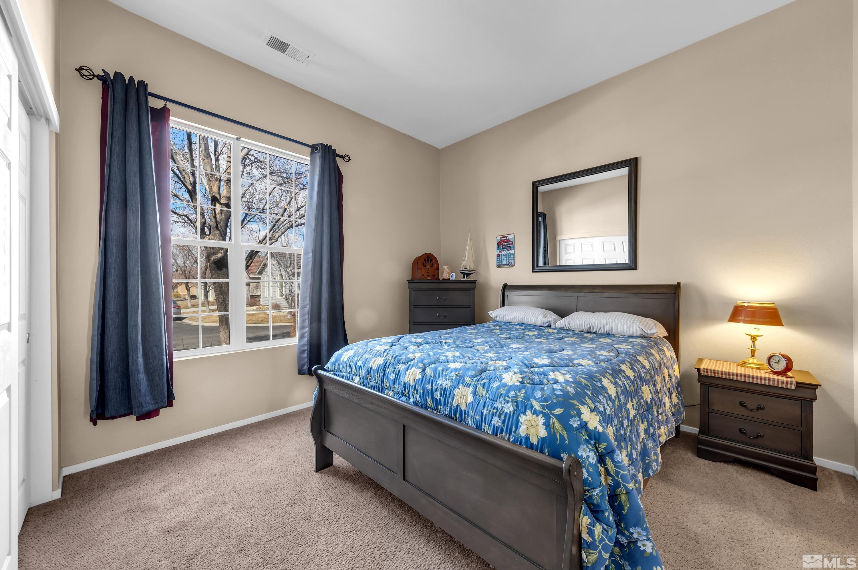 1496 Gaucho Lane Reno, NV 89521 - Photo 25 of 40 a bedroom with a bed and a large window