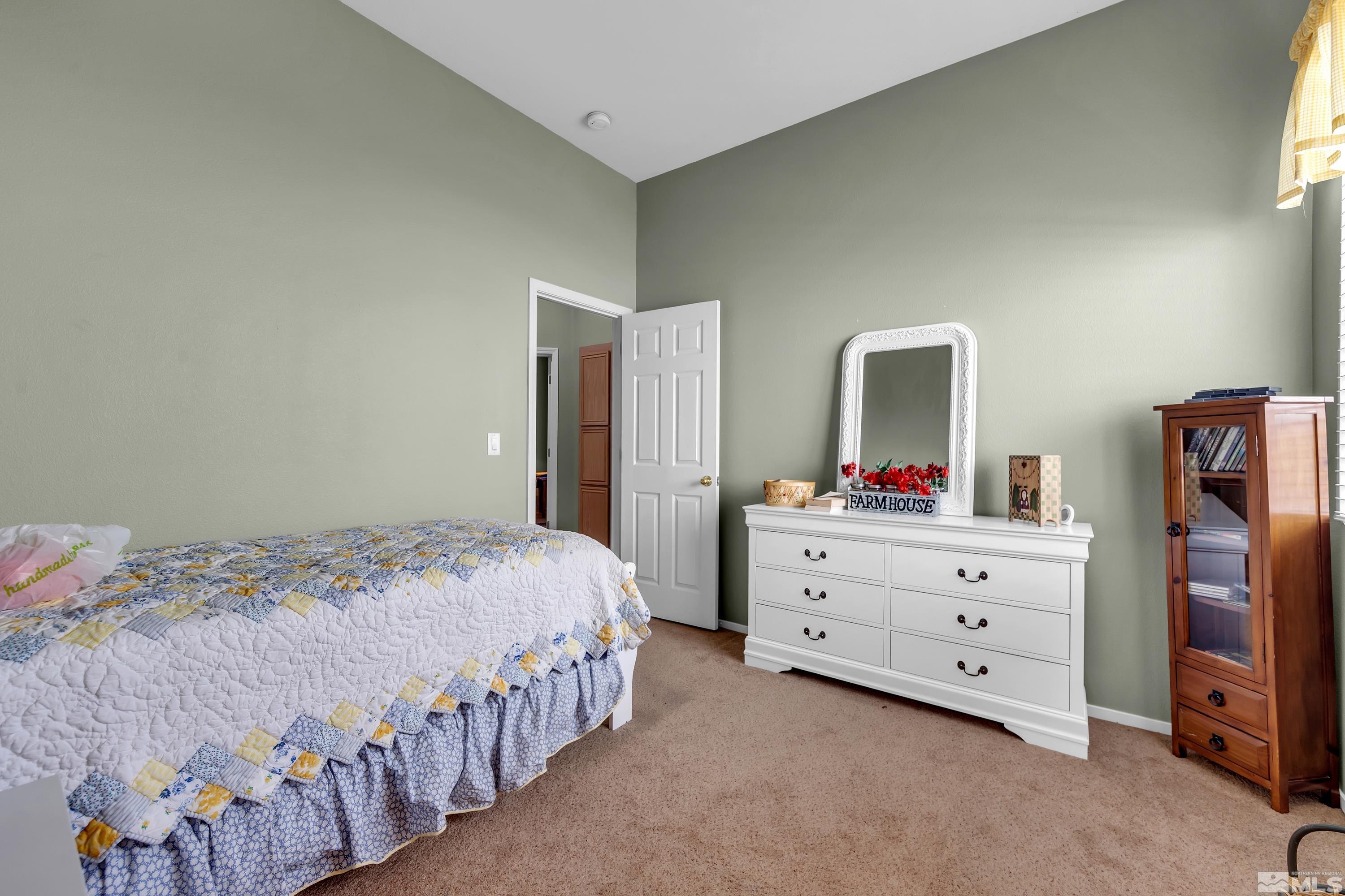 1496 Gaucho Lane Reno, NV 89521 - Photo 26 of 40 a bedroom with a bed and a dresser in it