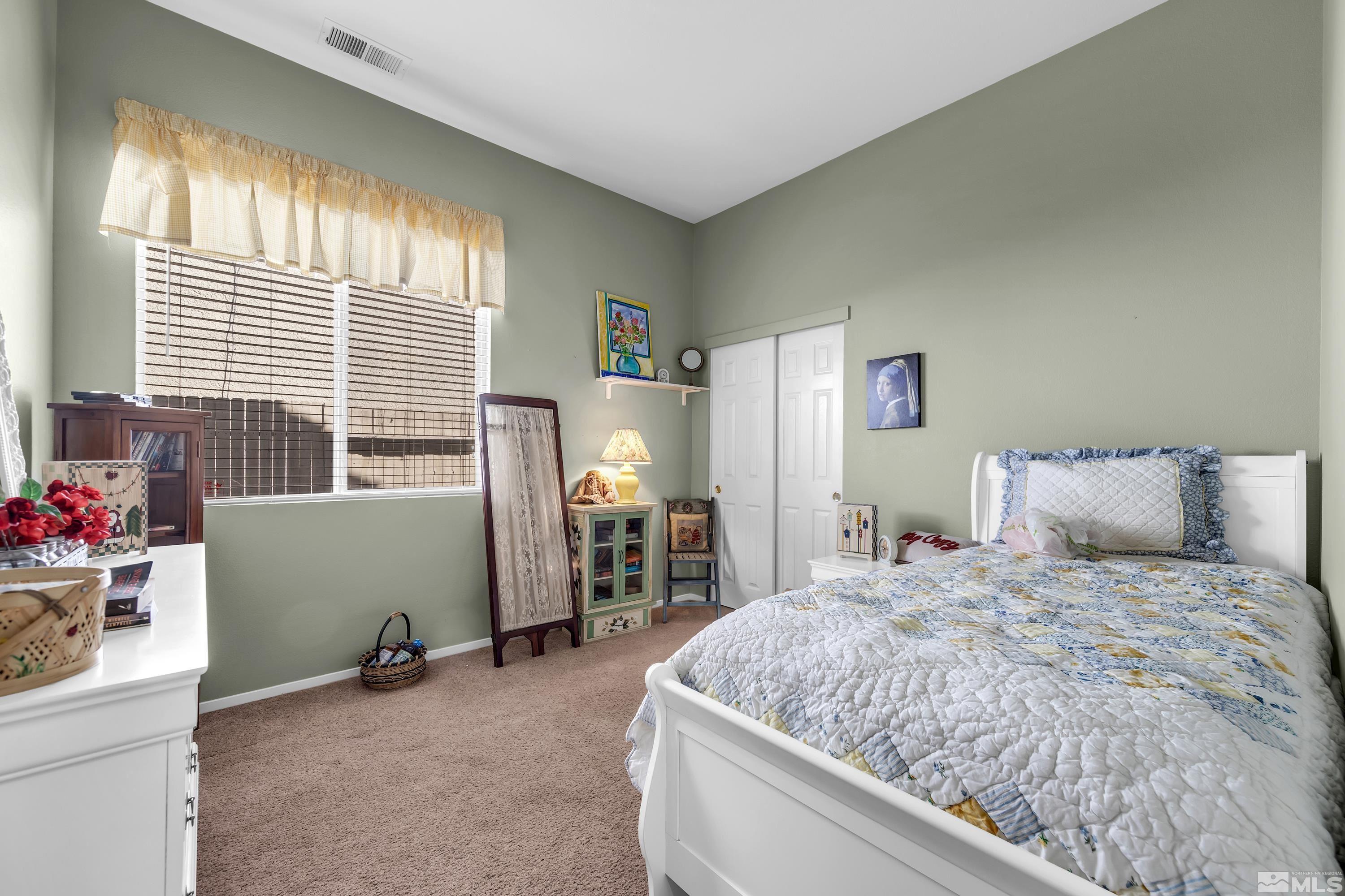1496 Gaucho Lane Reno, NV 89521 - Photo 27 of 40 a bedroom with a bed and windows