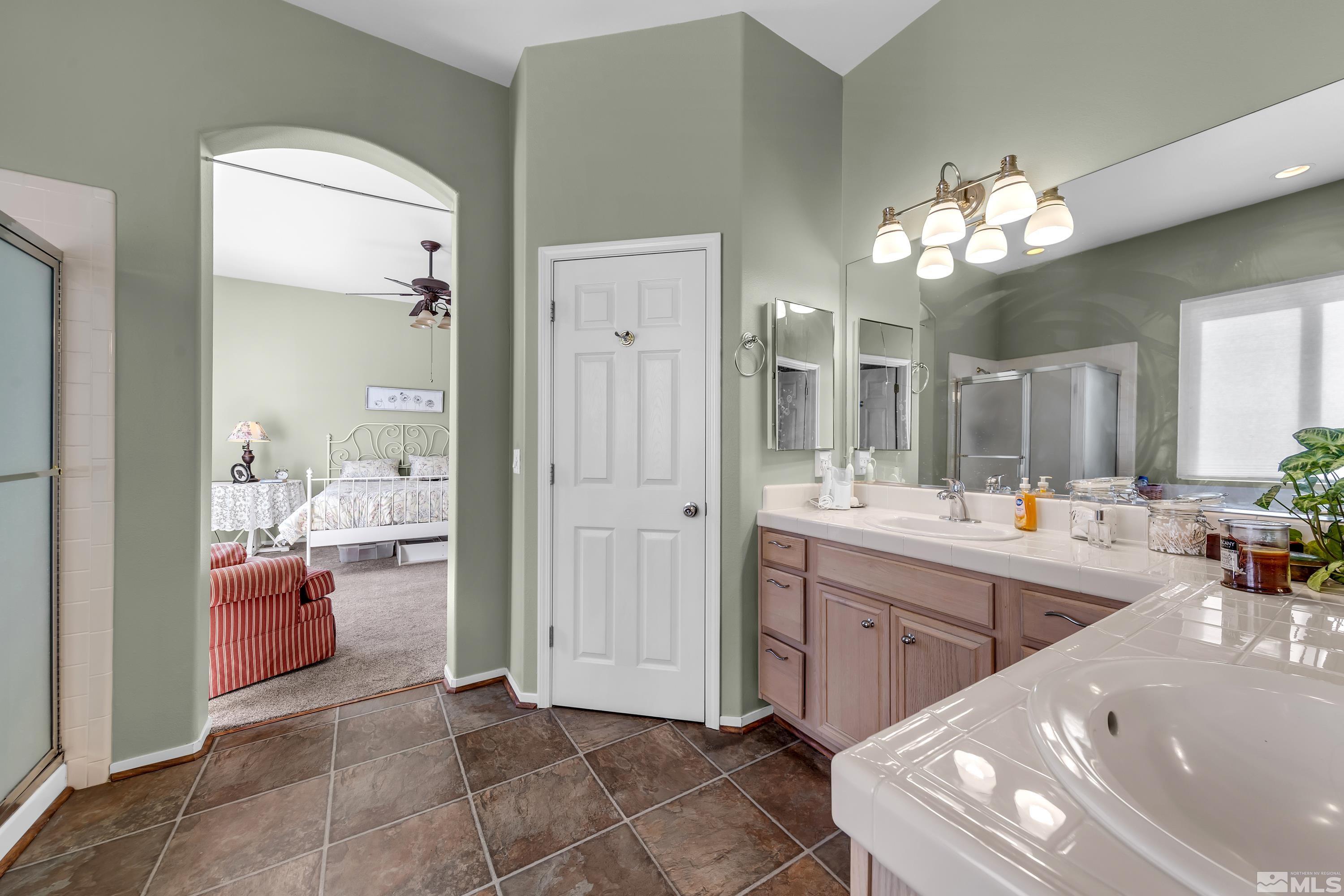 1496 Gaucho Lane Reno, NV 89521 - Photo 28 of 40 a large bathroom with a large tub and sink