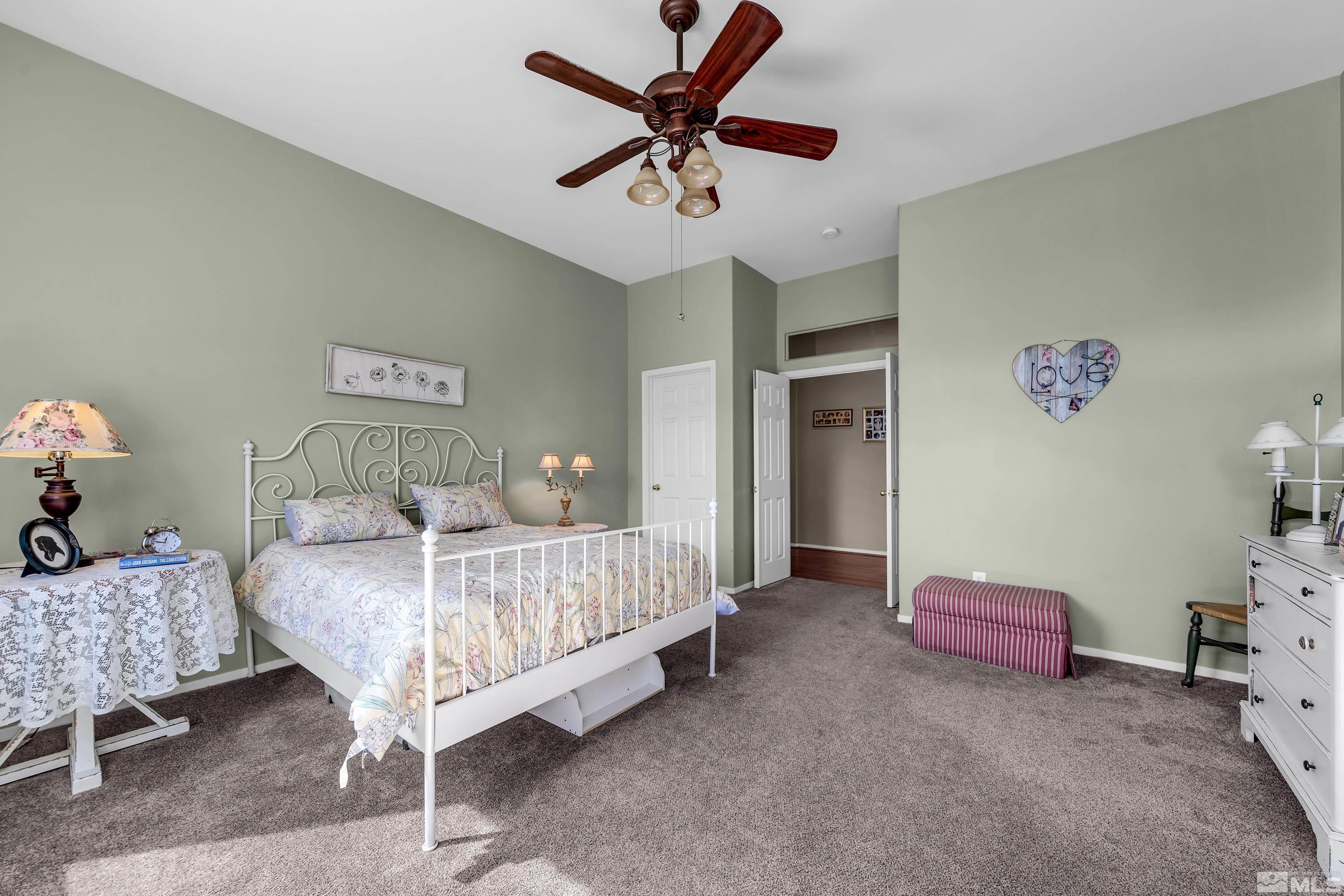 1496 Gaucho Lane Reno, NV 89521 - Photo 31 of 40 a bedroom with a bed and a chandelier