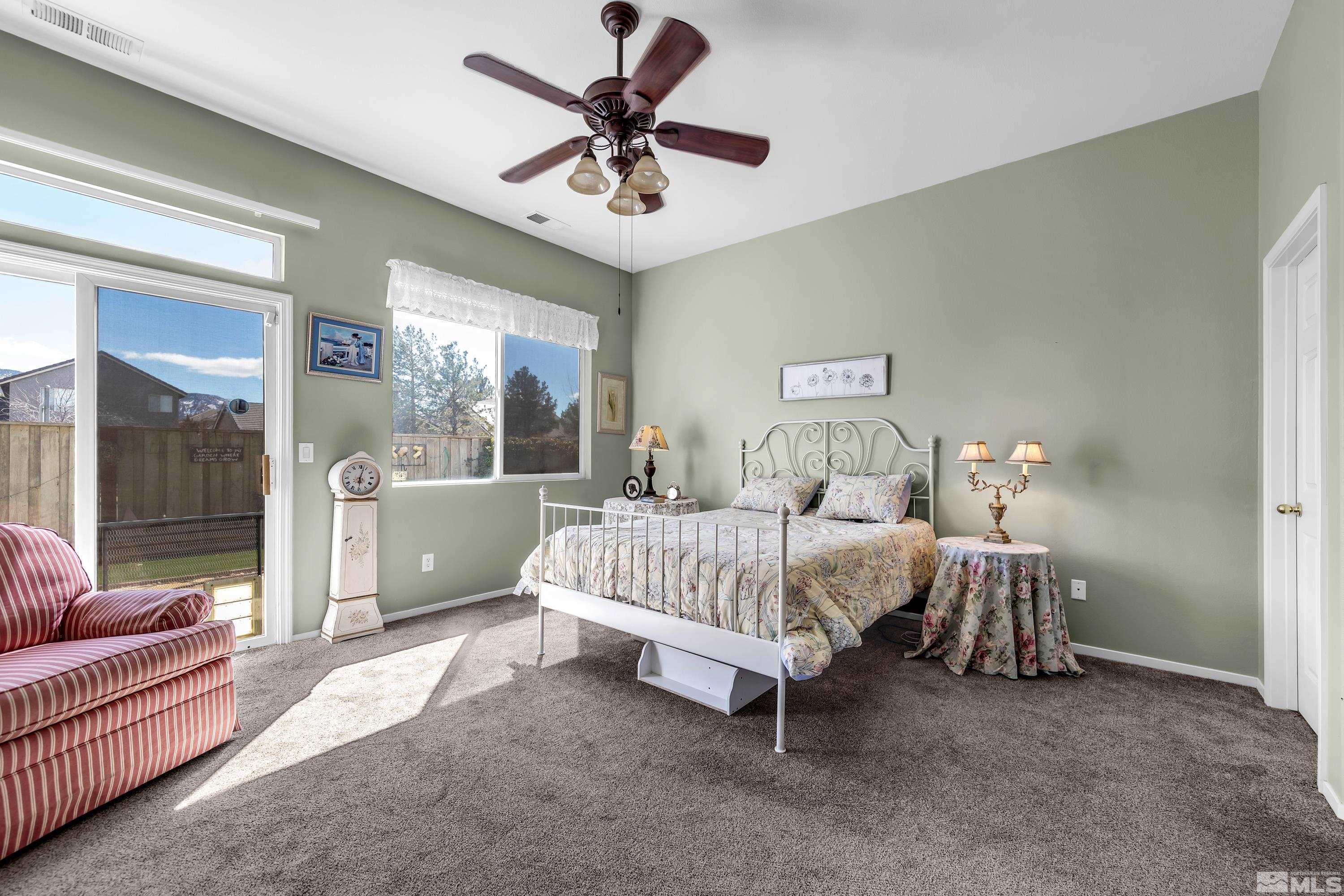 1496 Gaucho Lane Reno, NV 89521 - Photo 32 of 40 a spacious bedroom with a bed and a couch
