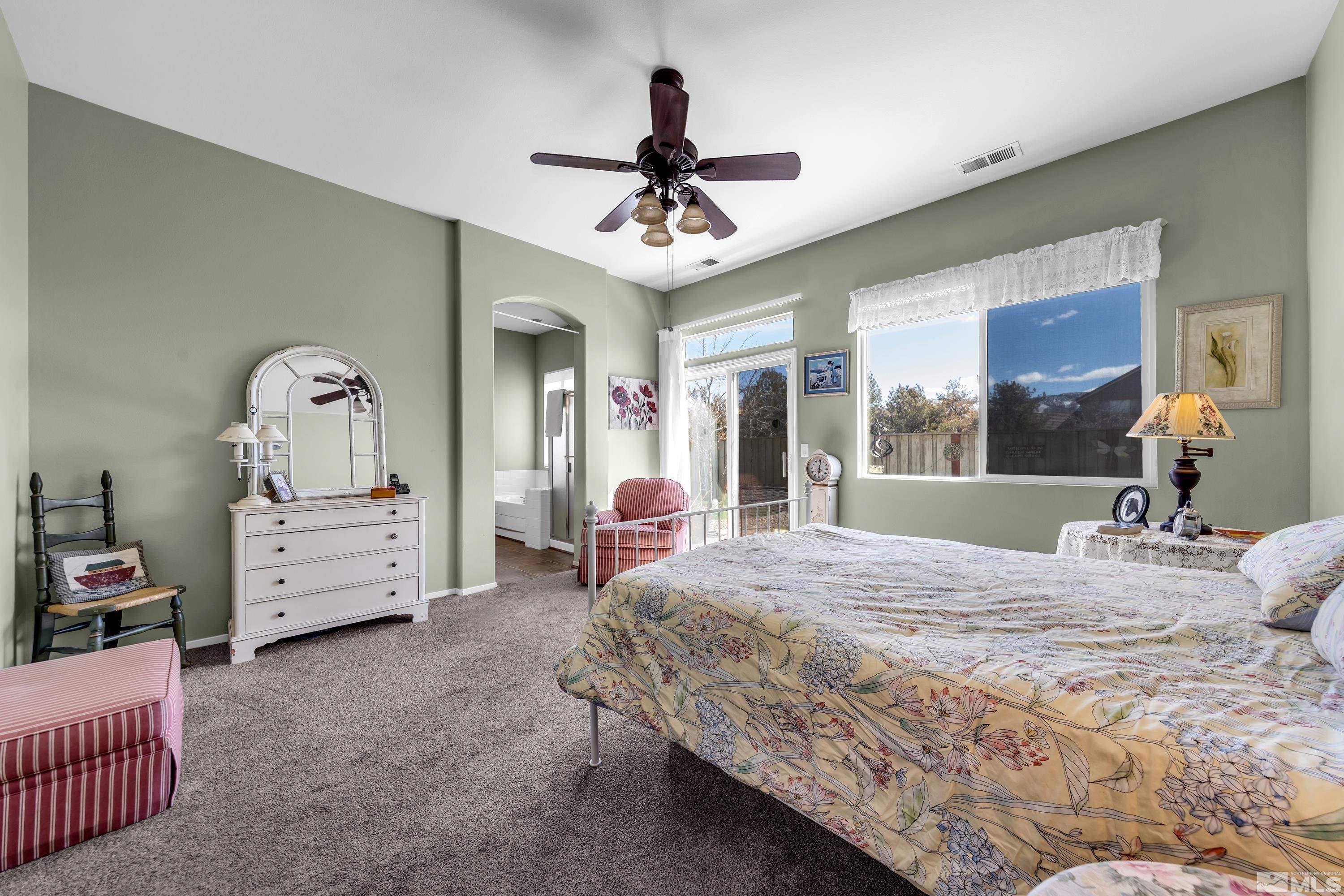 1496 Gaucho Lane Reno, NV 89521 - Photo 33 of 40 a bedroom with a bed and a chandelier