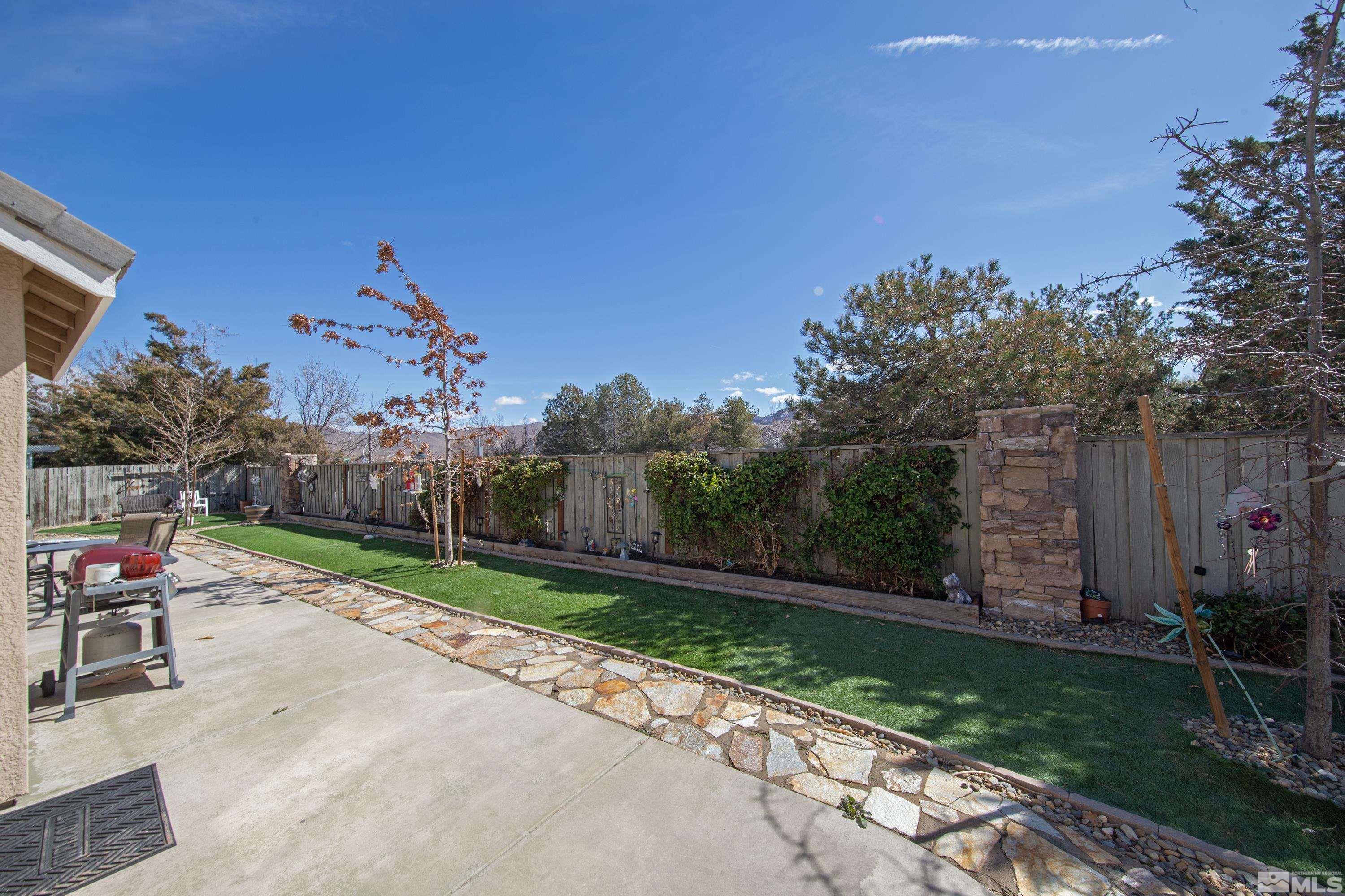 1496 Gaucho Lane Reno, NV 89521 - Photo 35 of 40 a wooden bench sitting in the middle of a park
