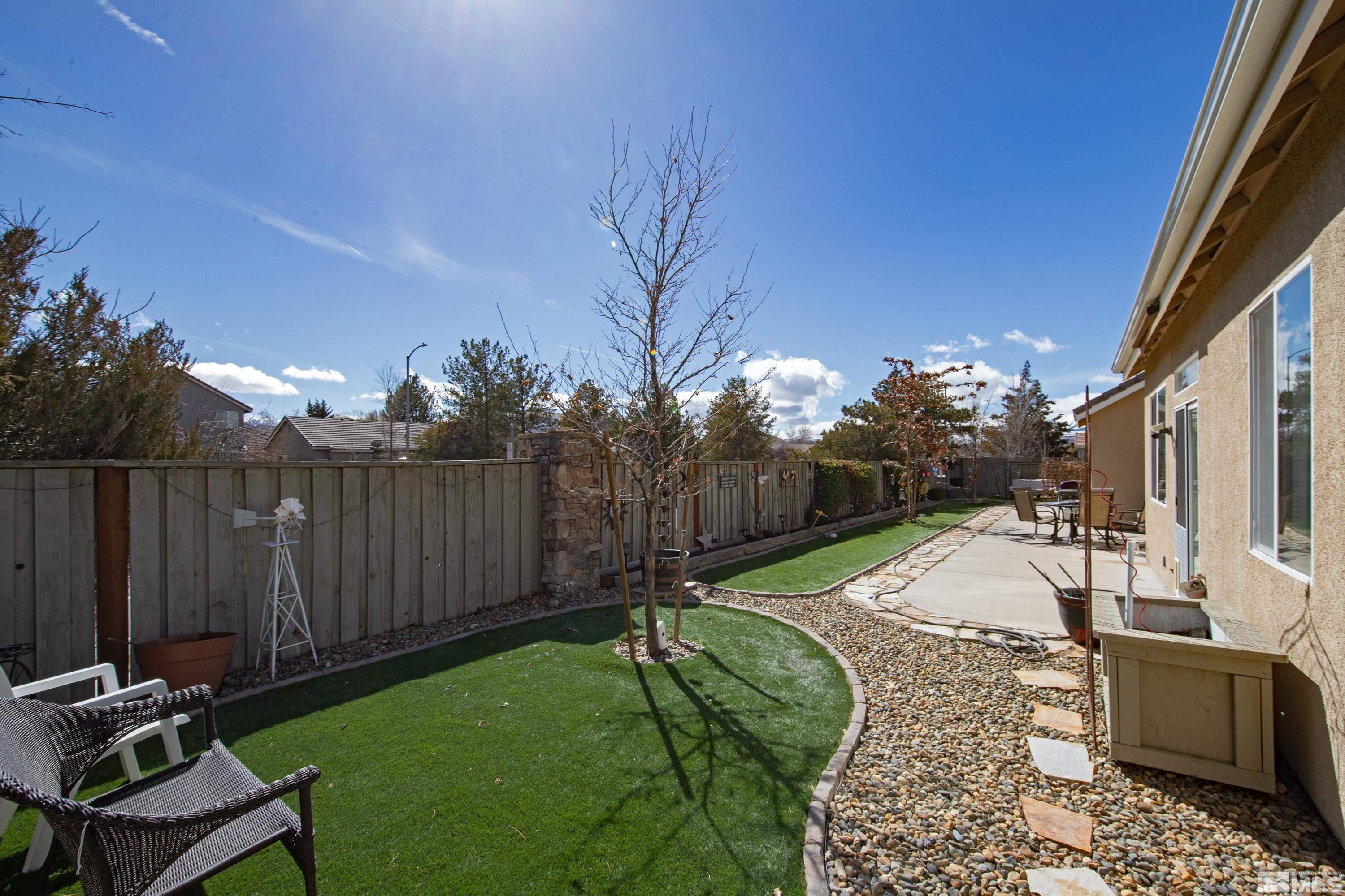1496 Gaucho Lane Reno, NV 89521 - Photo 37 of 40 a view of a backyard with wooden fence