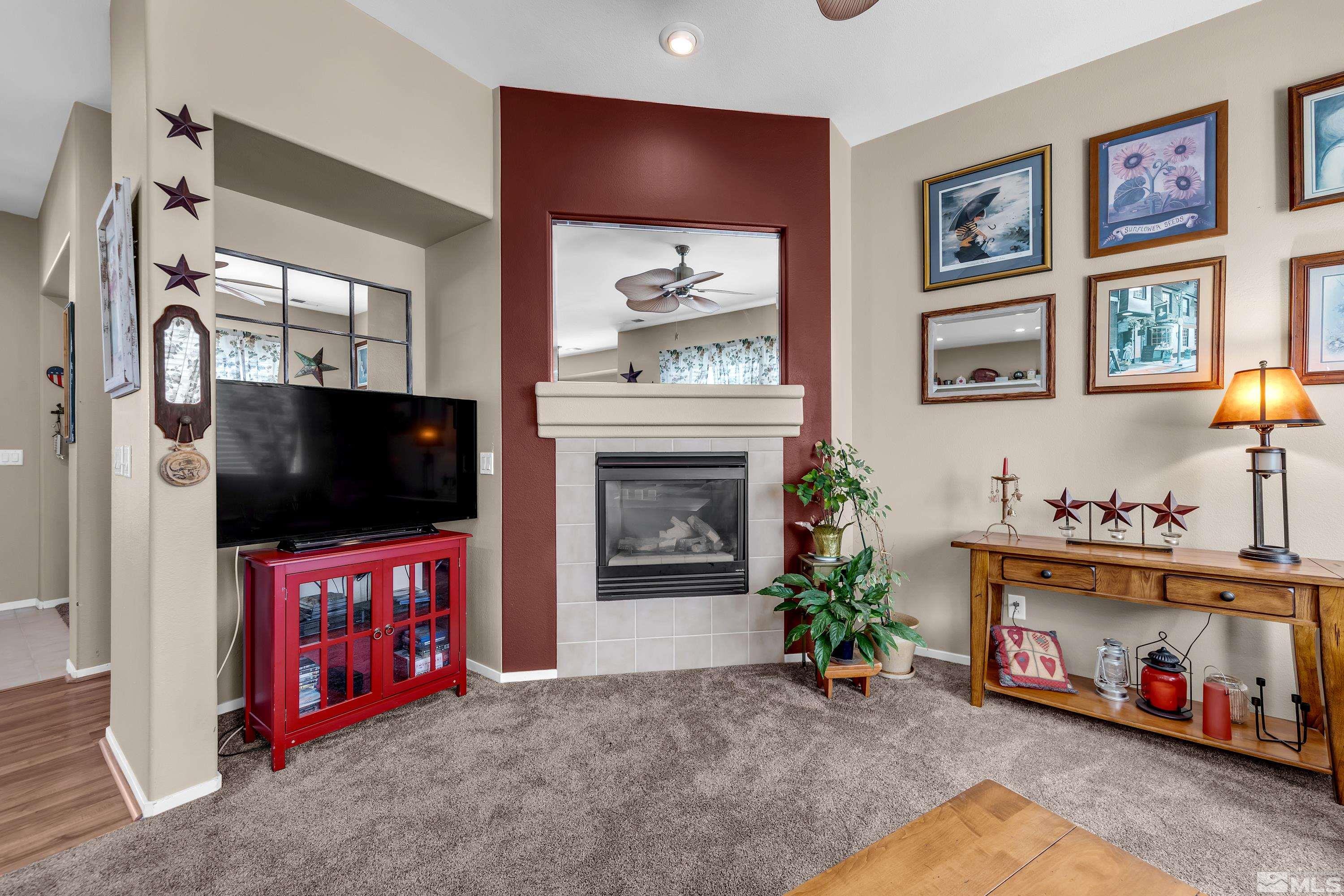 1496 Gaucho Lane Reno, NV 89521 - Photo 4 of 40 a living room with furniture and a flat screen tv