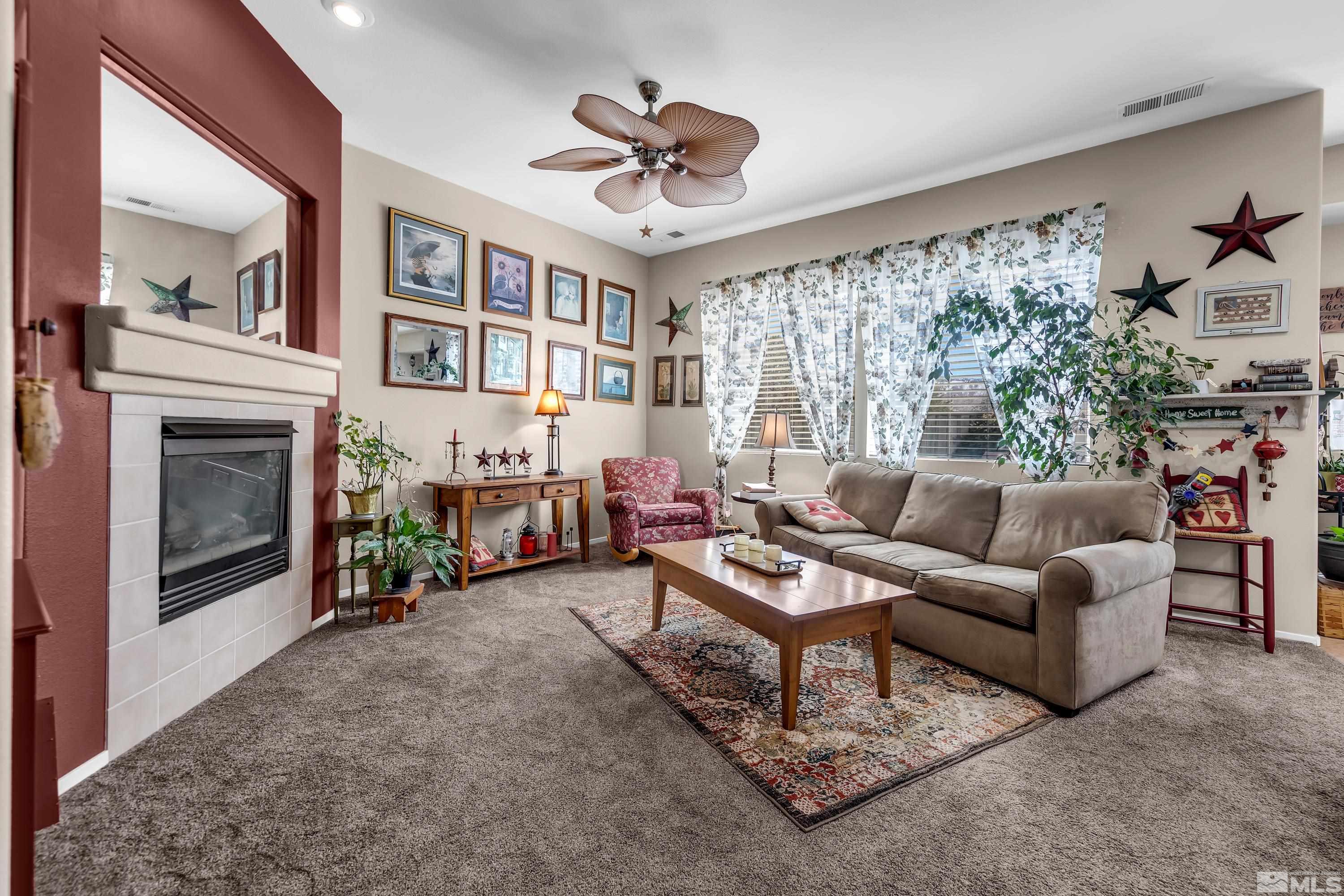 1496 Gaucho Lane Reno, NV 89521 - Photo 5 of 40 a living room with furniture and a fireplace