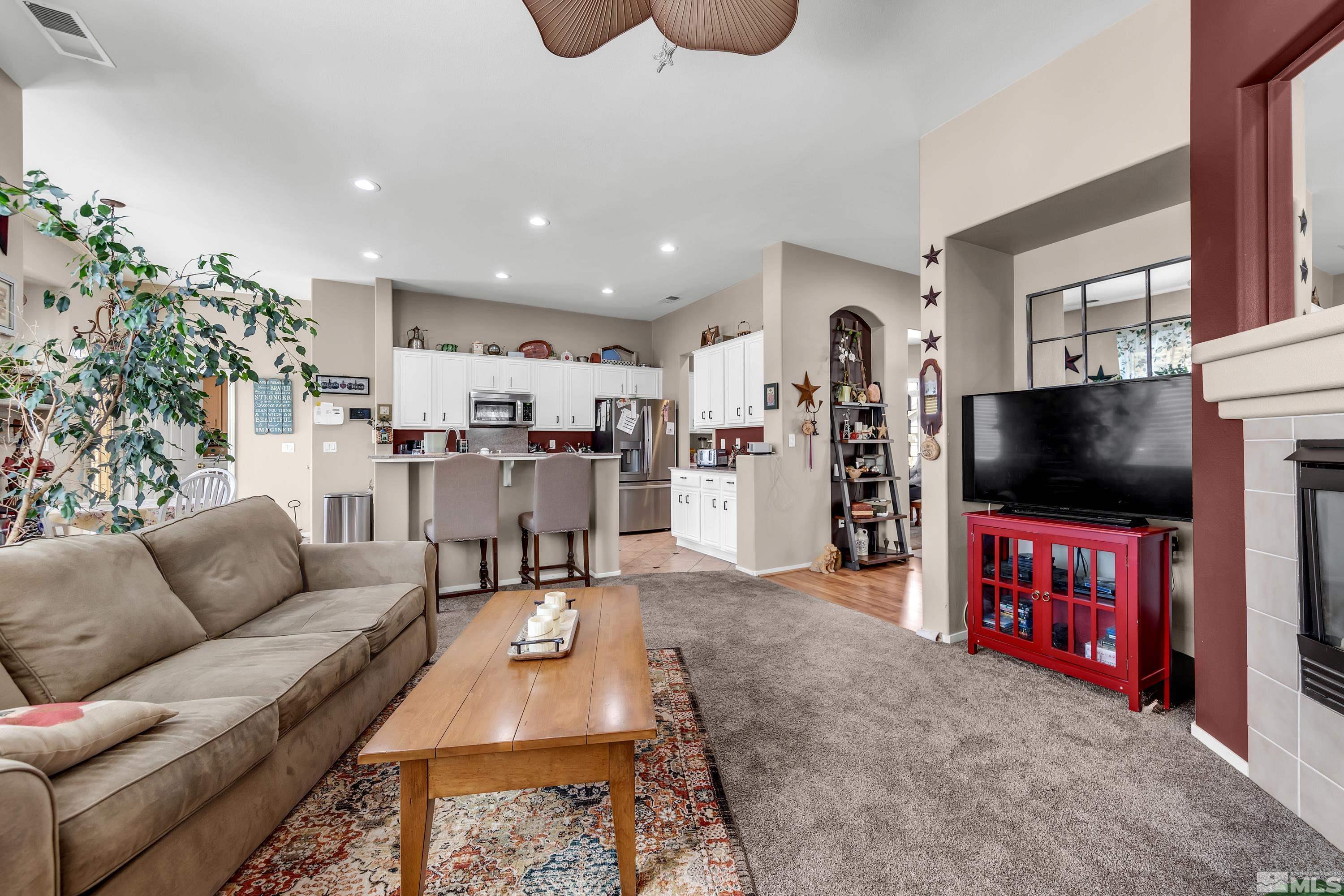 1496 Gaucho Lane Reno, NV 89521 - Photo 6 of 40 a living room with furniture and a flat screen tv
