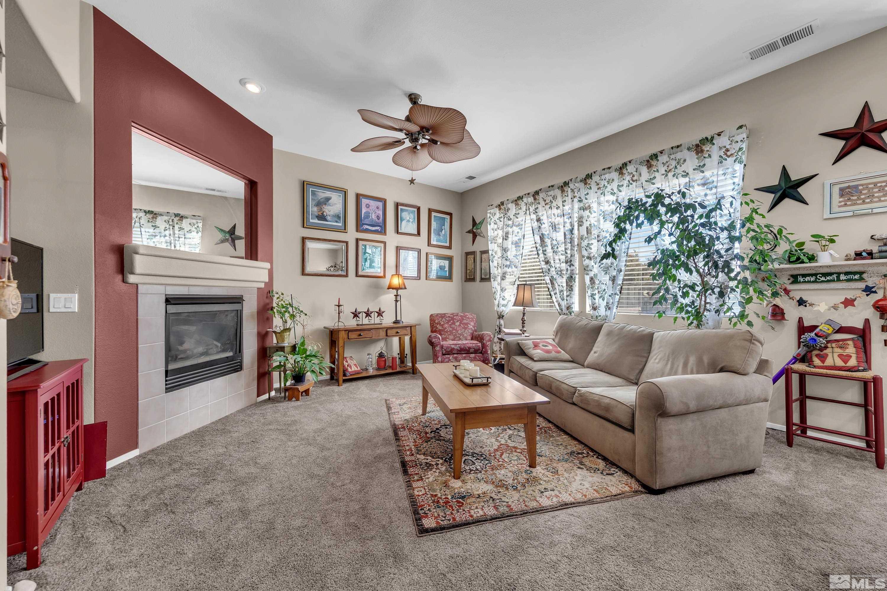 1496 Gaucho Lane Reno, NV 89521 - Photo 7 of 40 a living room with furniture a fireplace and a large window