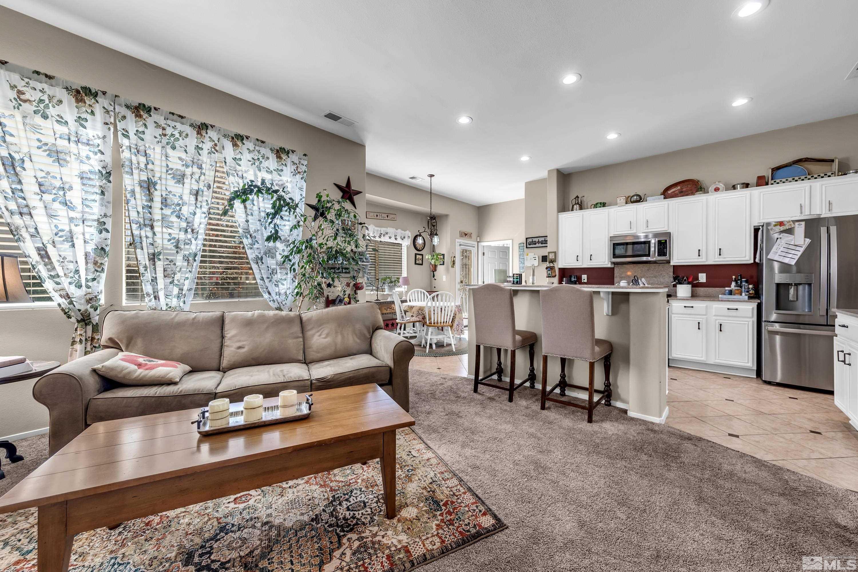 1496 Gaucho Lane Reno, NV 89521 - Photo 8 of 40 a living room with furniture and a dining table with kitchen view