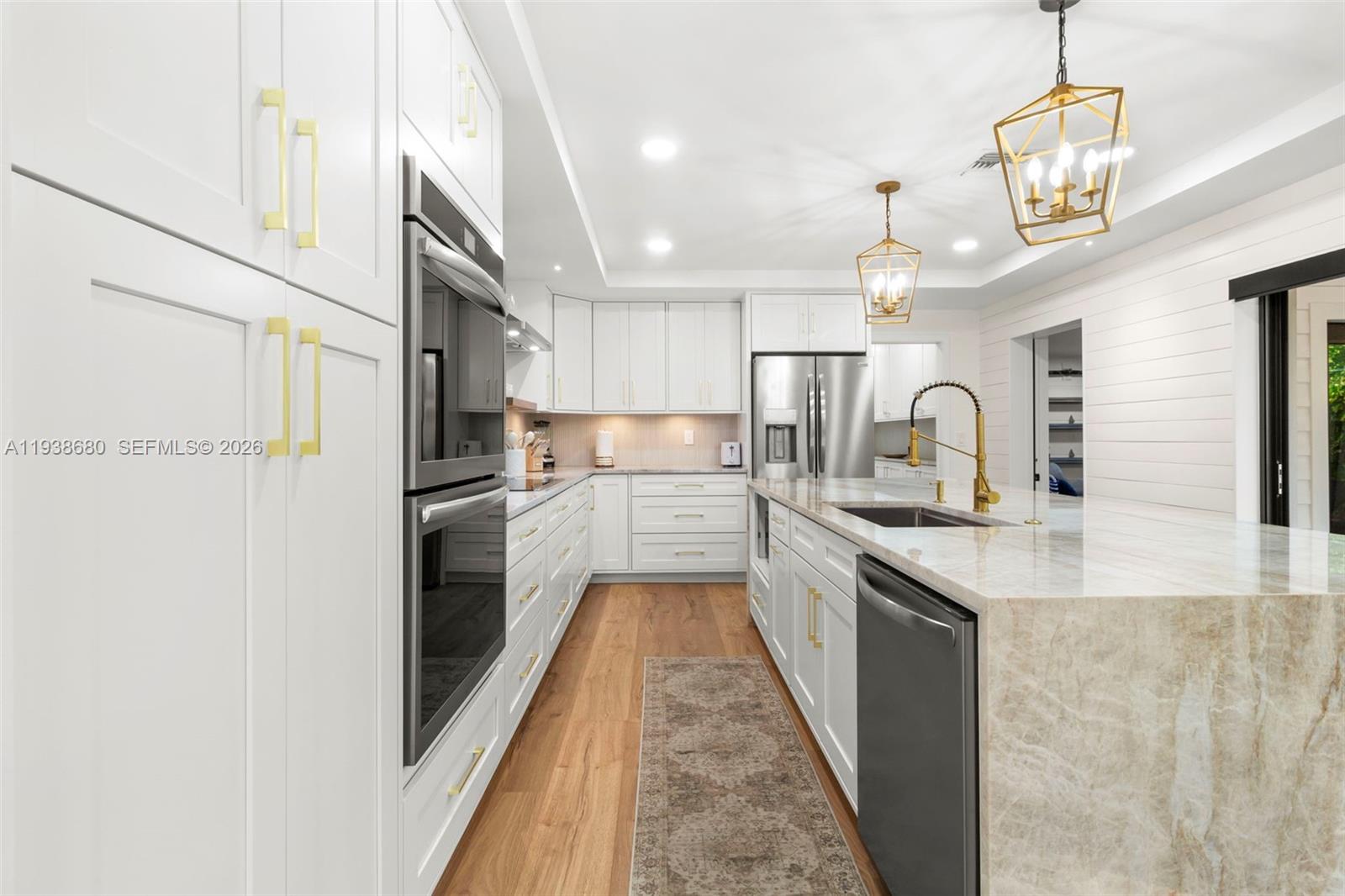 3540 Northeast 28th Avenue Lighthouse Point, FL 33064 - Photo 11 of 47 a kitchen with stainless steel appliances granite countertop a refrigerator a oven a sink and a stove