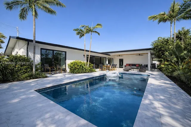 a view of a house with a swimming pool and a patio