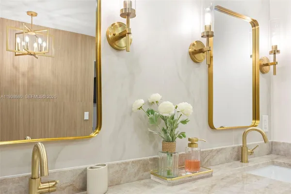 a bedroom with two beds and painting on the wall